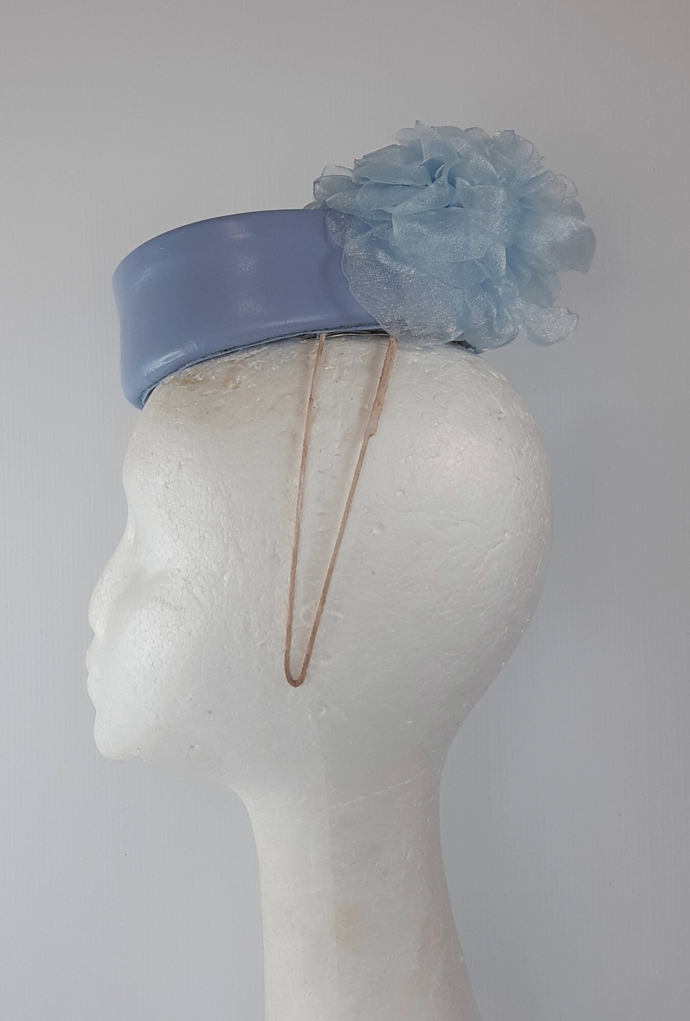 A picture of a Blue Leather Millinery Headpiece by Melissa Rath Millinery.