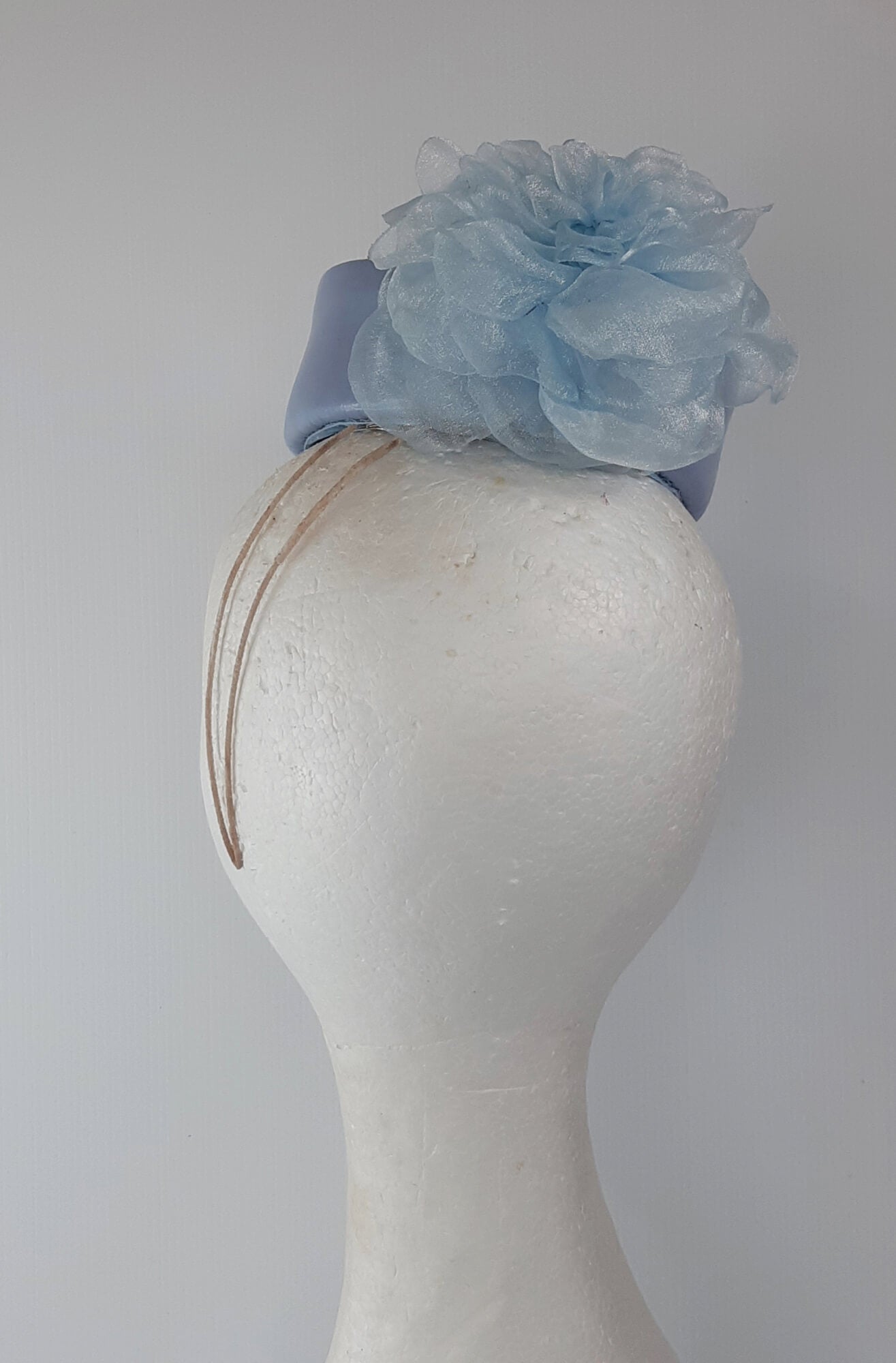 A picture of a Blue Leather Millinery Headpiece by Melissa Rath Millinery.