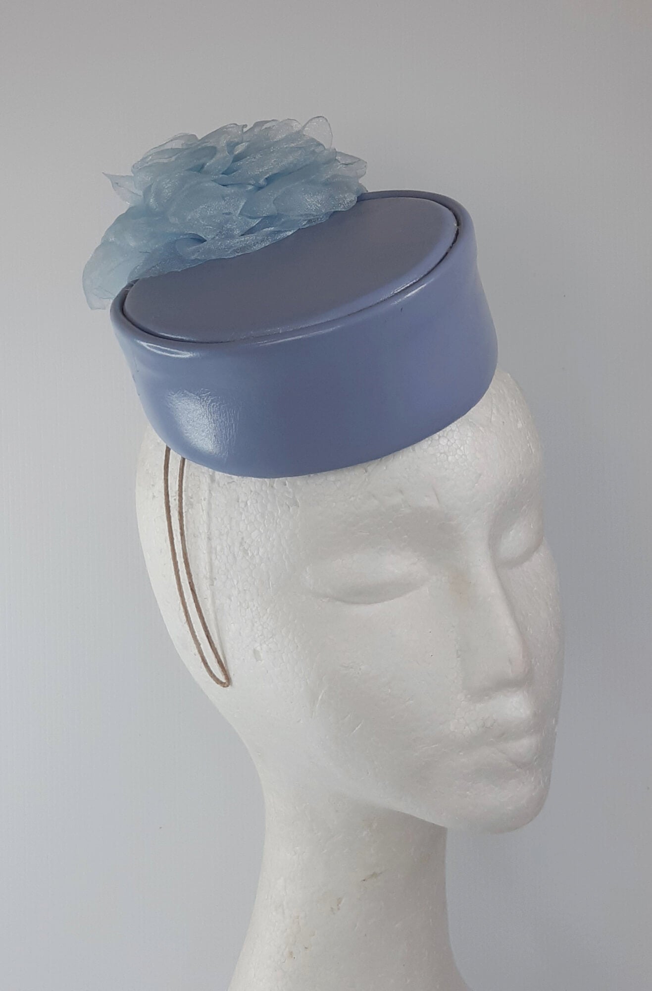 A picture of a Blue Leather Millinery Headpiece by Melissa Rath Millinery.