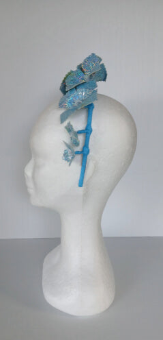A picture of a blue pleather millinery crown by Melissa Rath Millinery.