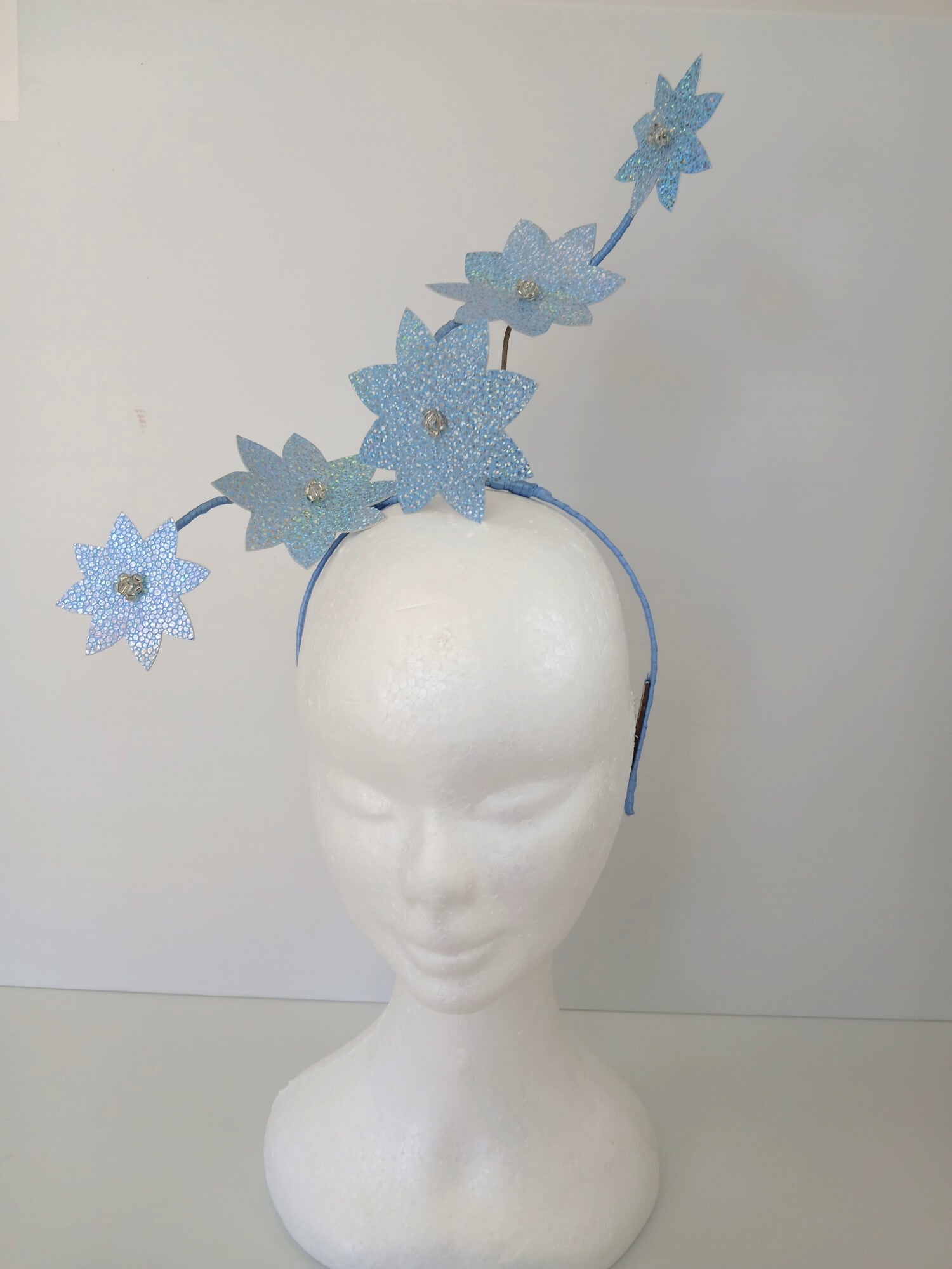 A picture of a Blue Pleather Millinery Fascinator by Melissa Rath Millinery.