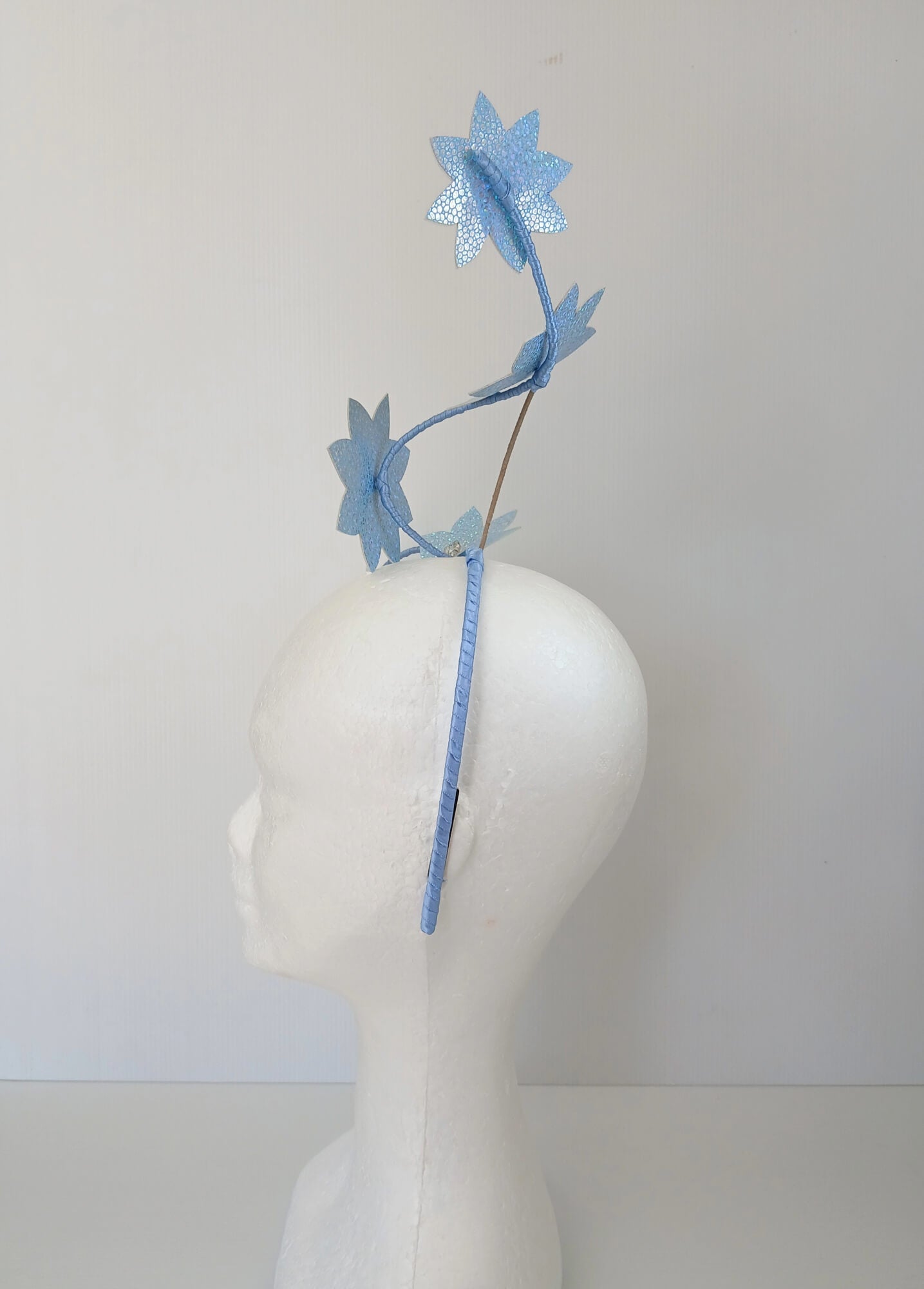 A picture of a Blue Pleather Millinery Fascinator by Melissa Rath Millinery.