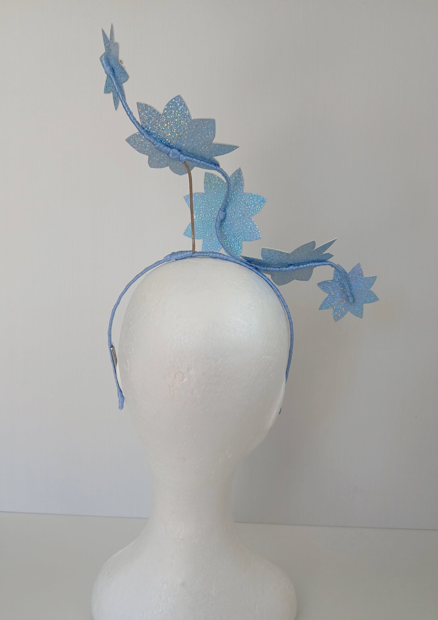 A picture of a Blue Pleather Millinery Fascinator by Melissa Rath Millinery.