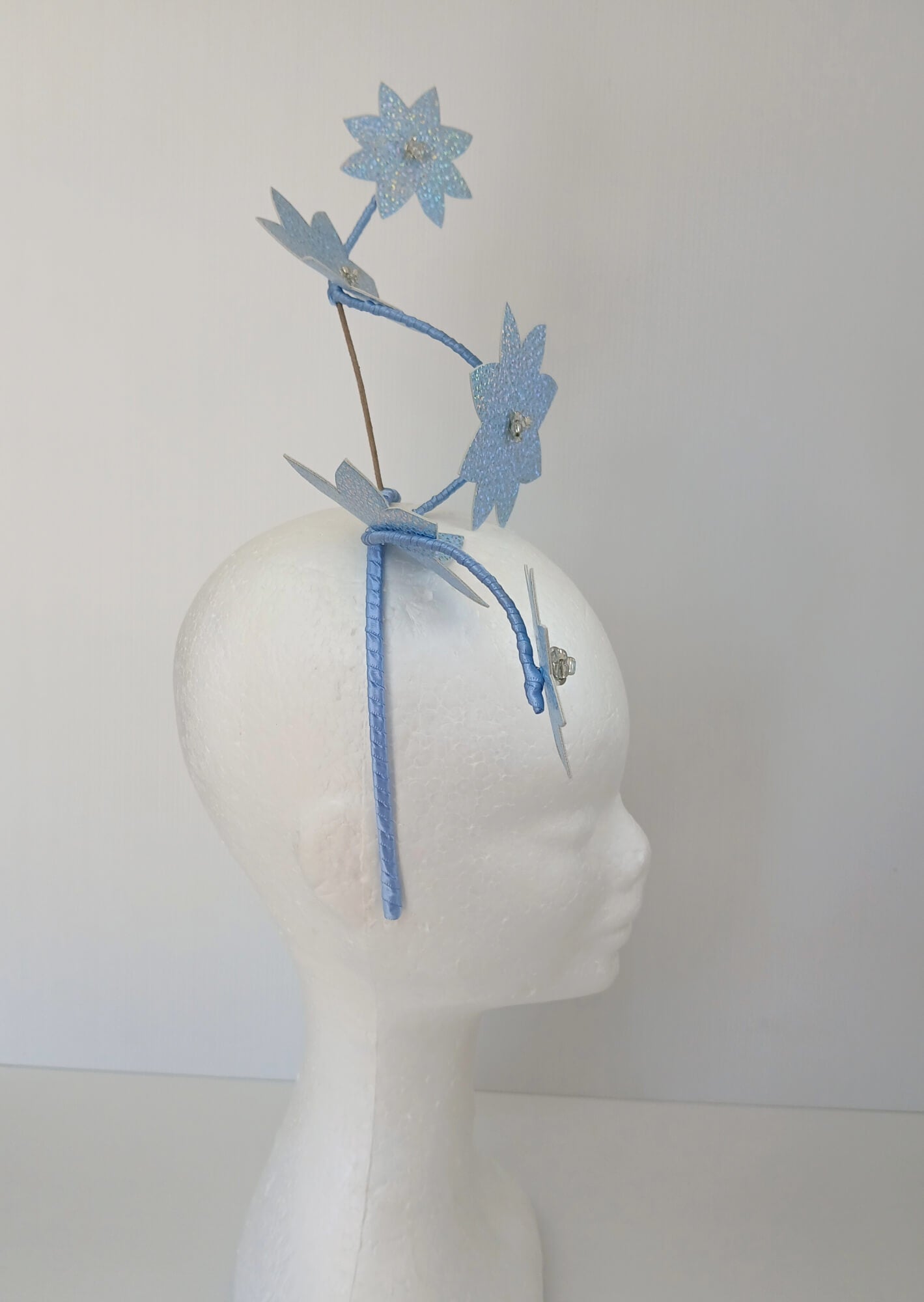 A picture of a Blue Pleather Millinery Fascinator by Melissa Rath Millinery.