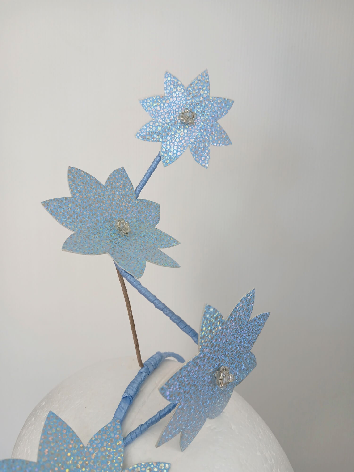 A picture of a Blue Pleather Millinery Fascinator by Melissa Rath Millinery.
