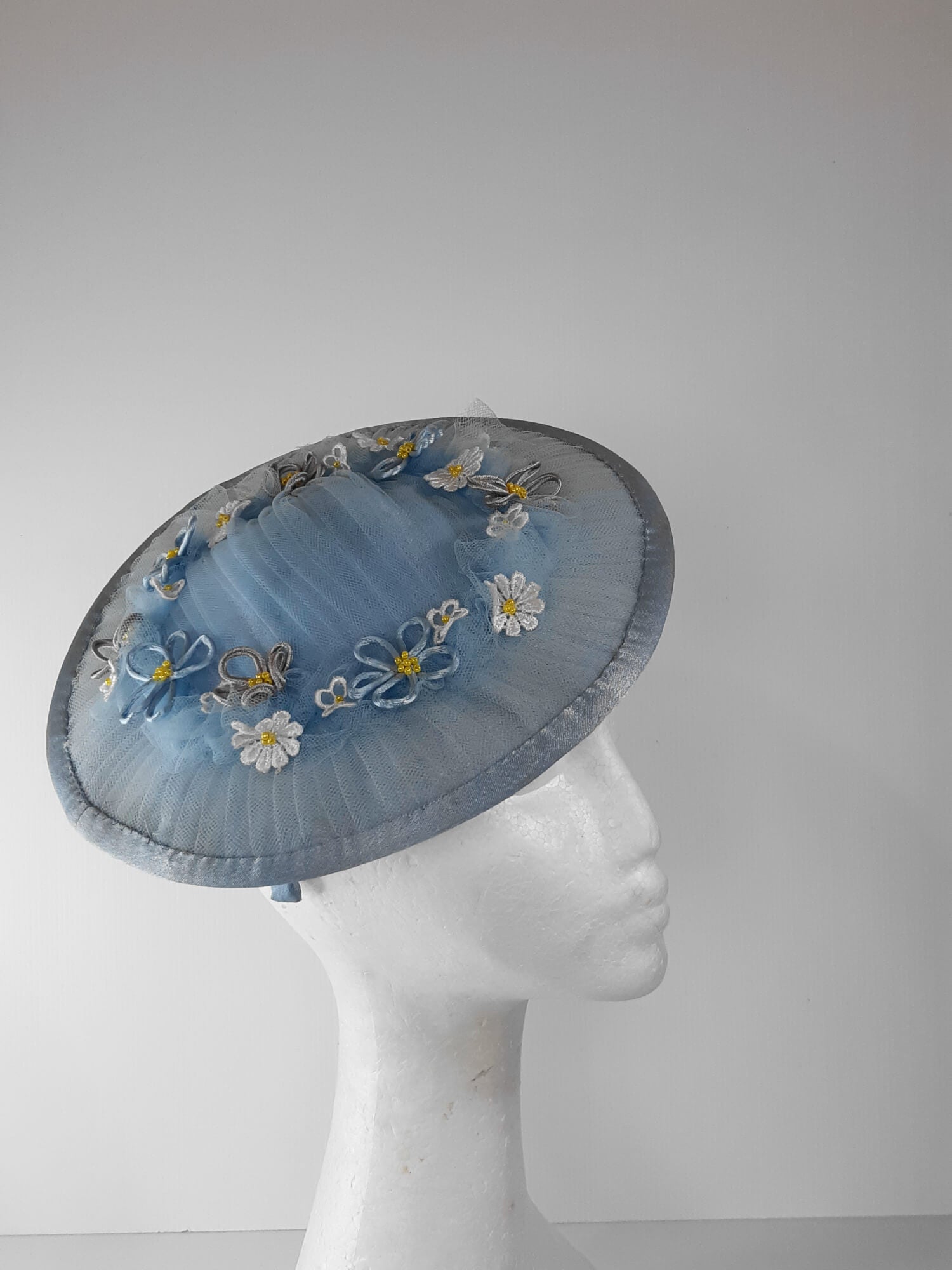 A picture of a Blue Tulle Saucer Hat by Melissa Rath Millinery.