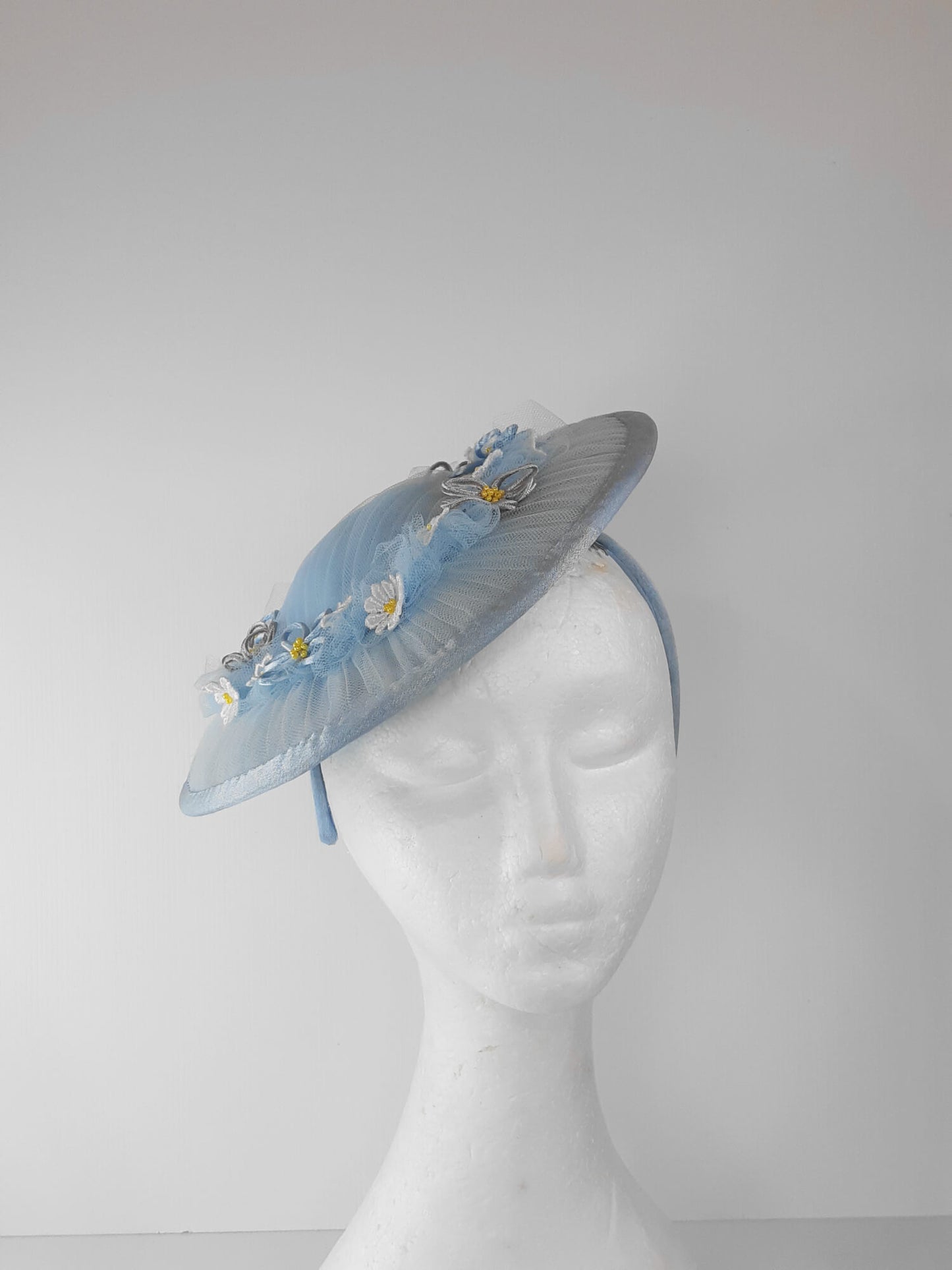 A picture of a Blue Tulle Saucer Hat by Melissa Rath Millinery.