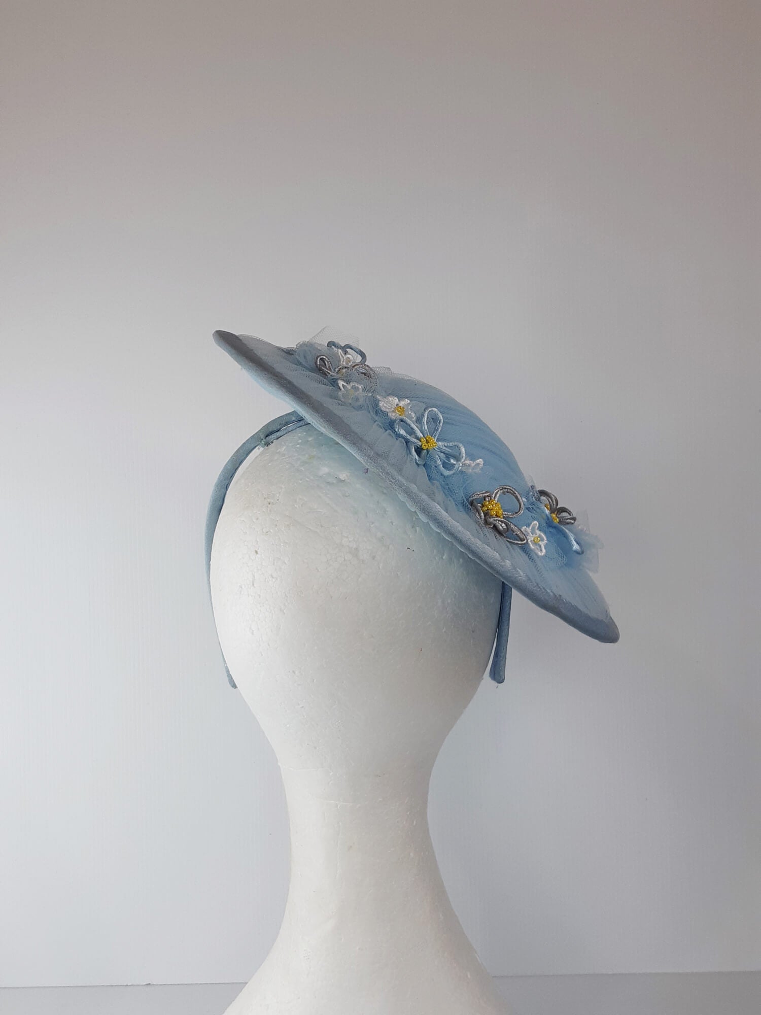 A picture of a Blue Tulle Saucer Hat by Melissa Rath Millinery.