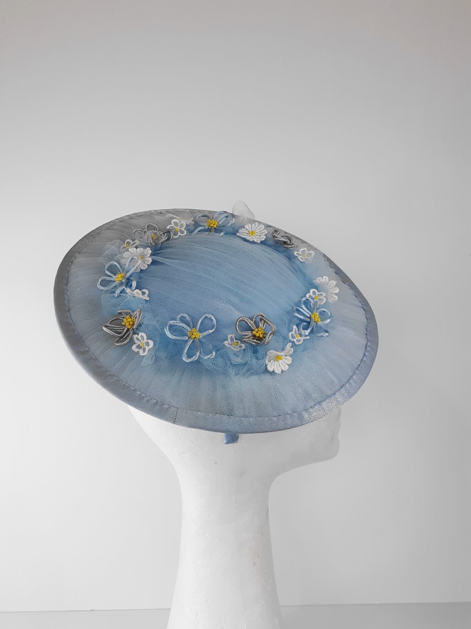 A picture of a Blue Tulle Saucer Hat by Melissa Rath Millinery.