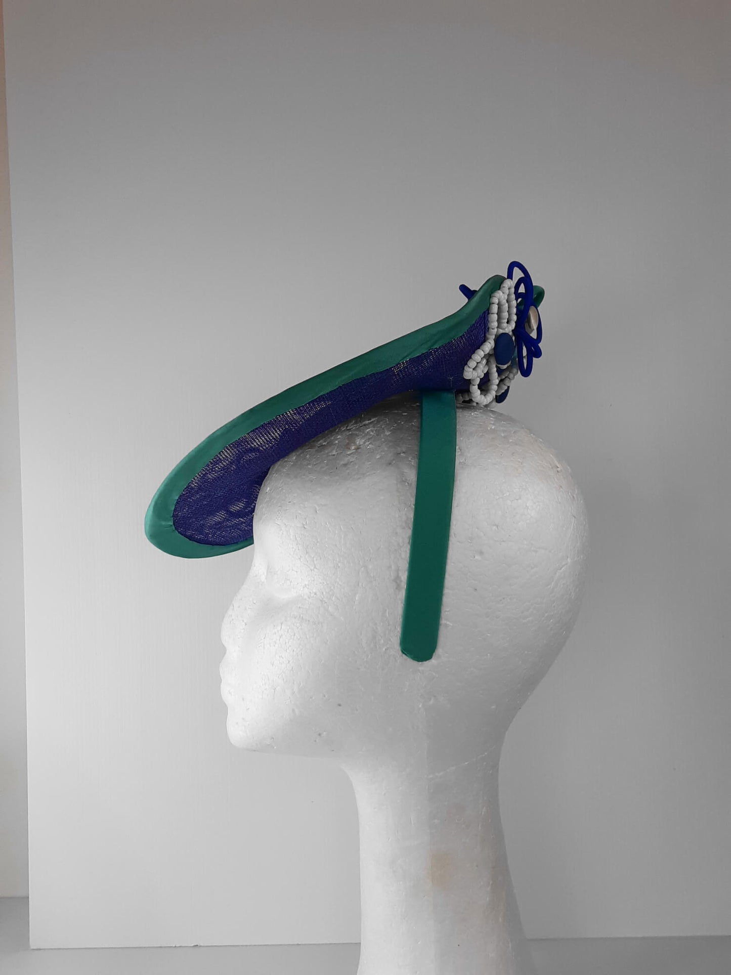 A picture of a Blue and Green Saucer Hat by Melissa Rath Millinery.
