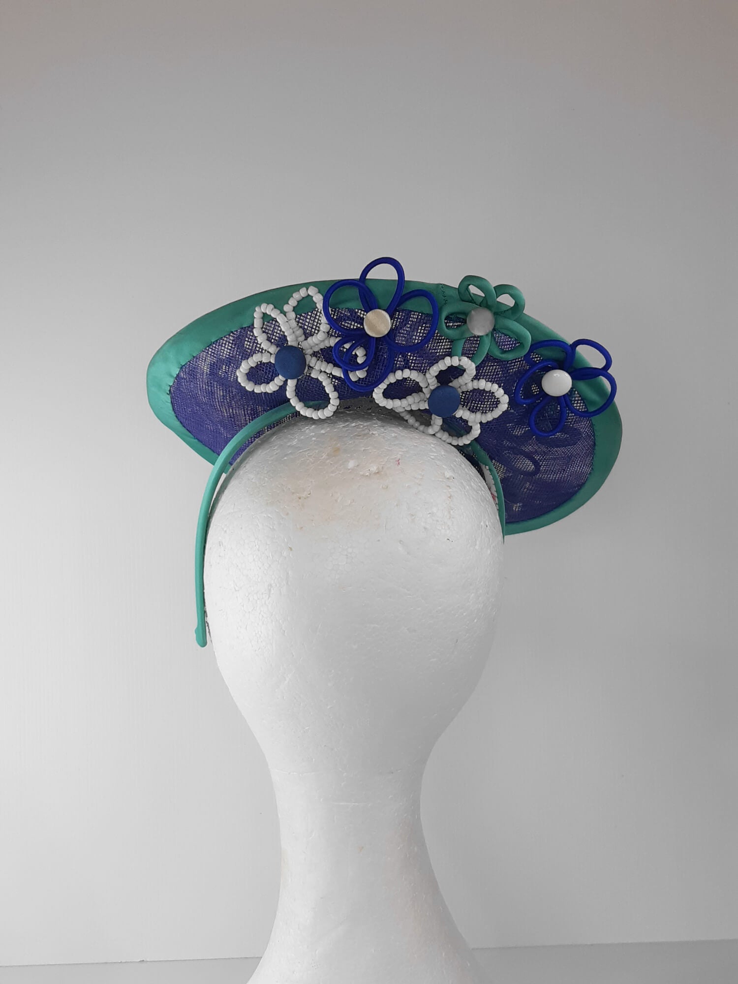 A picture of a Blue and Green Saucer Hat by Melissa Rath Millinery.