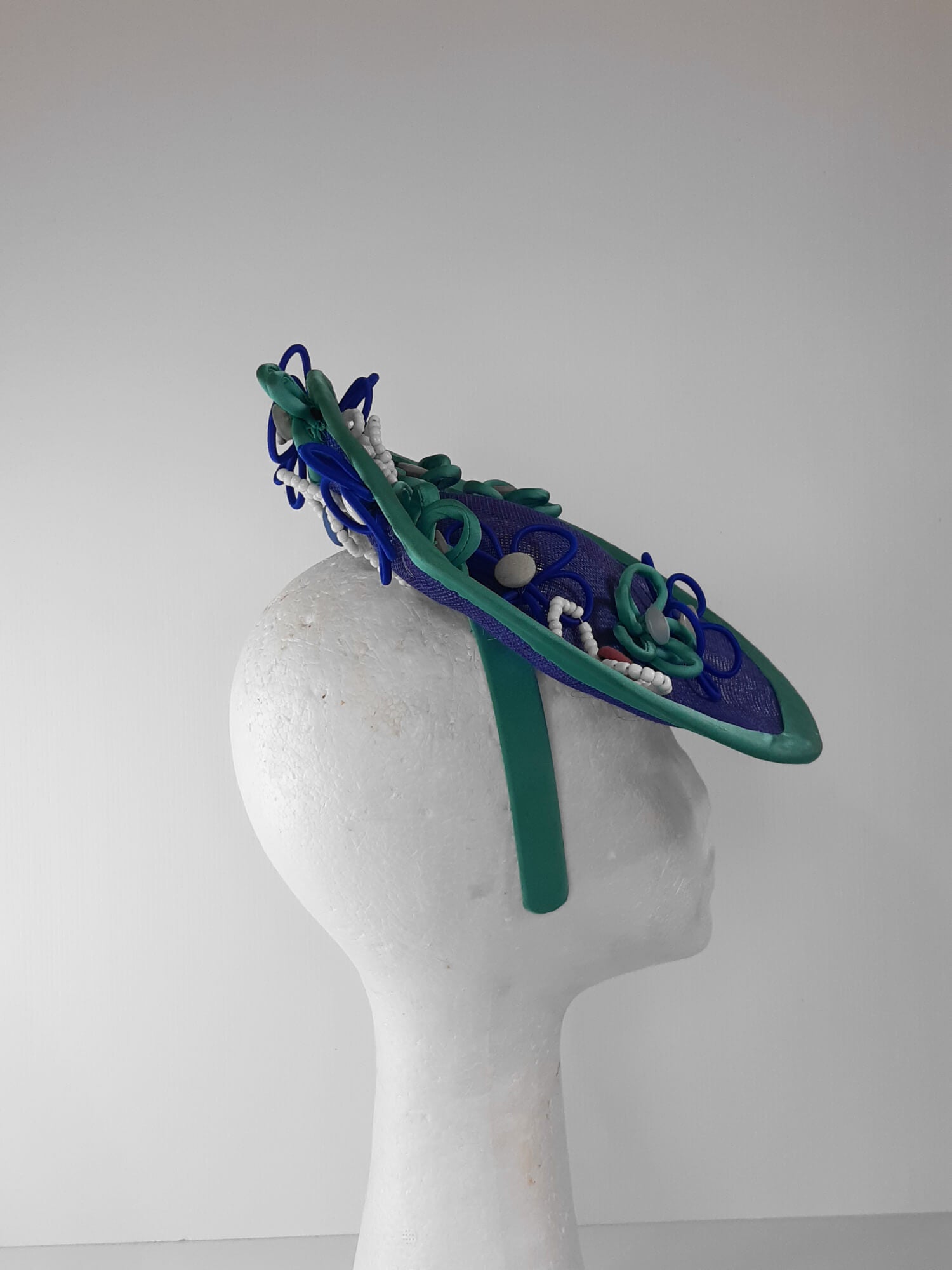A picture of a Blue and Green Saucer Hat by Melissa Rath Millinery.