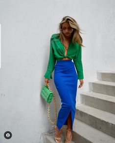 A picture of a woman wearing a blue and green outfit.