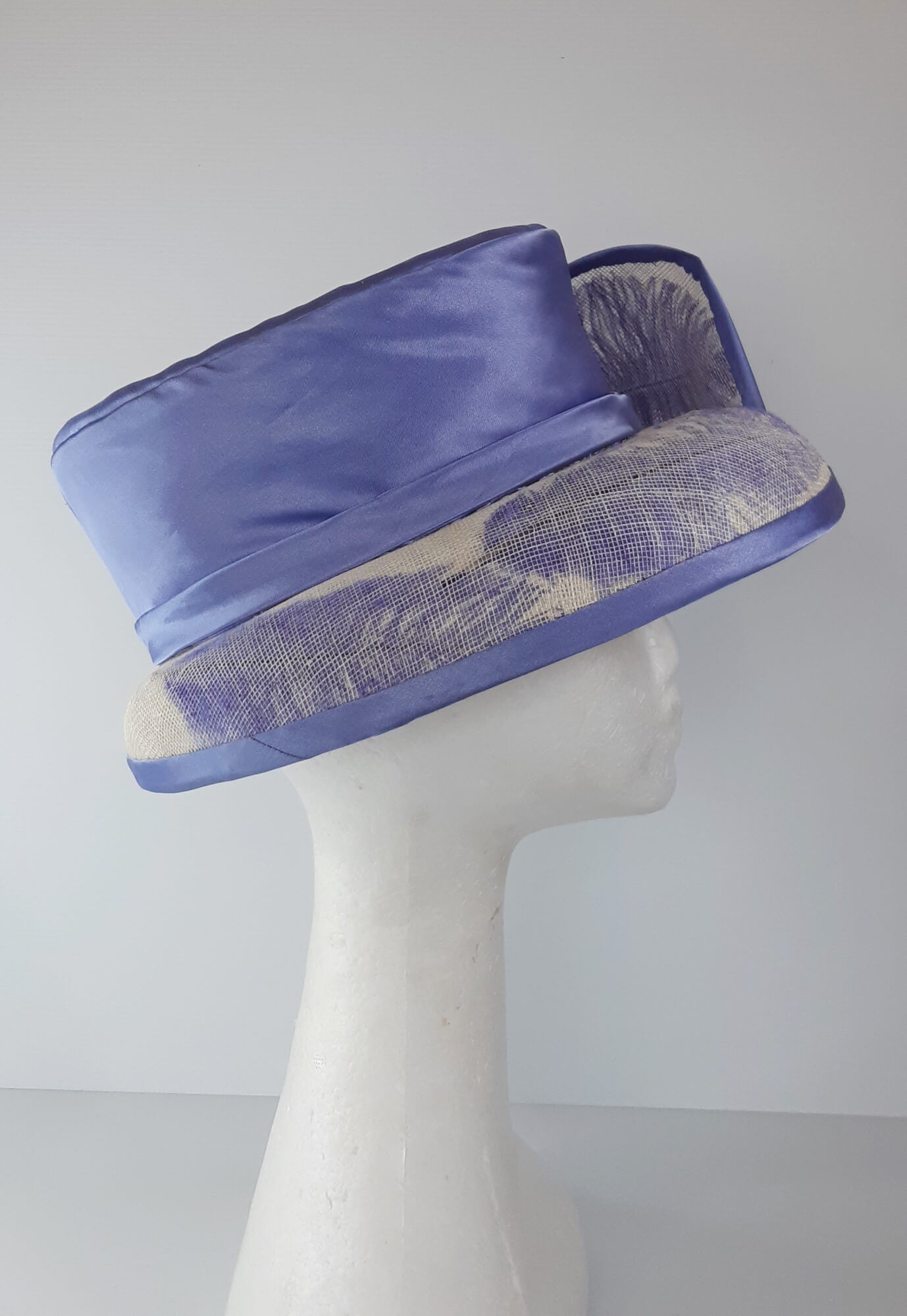 A picture of a blue and white picture hat by Melissa Rath Millinery.