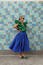 A picture of a woman wearing a blue and green outfit.