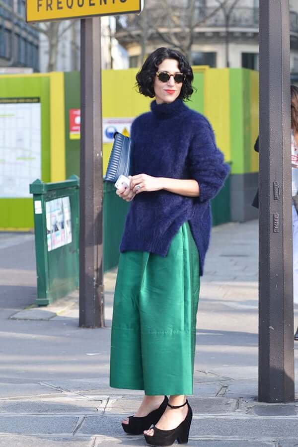 A picture of a woman wearing a blue and green outfit.