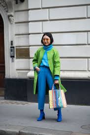 A picture of a woman wearing a blue and green outfit.