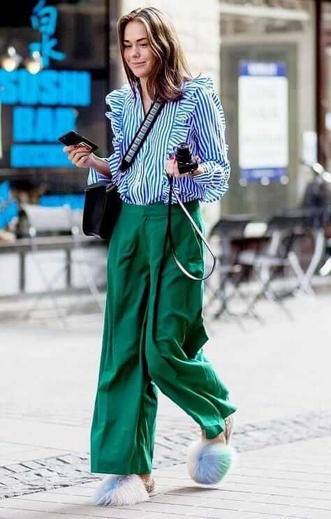 A picture of a woman wearing a blue and green outfit.
