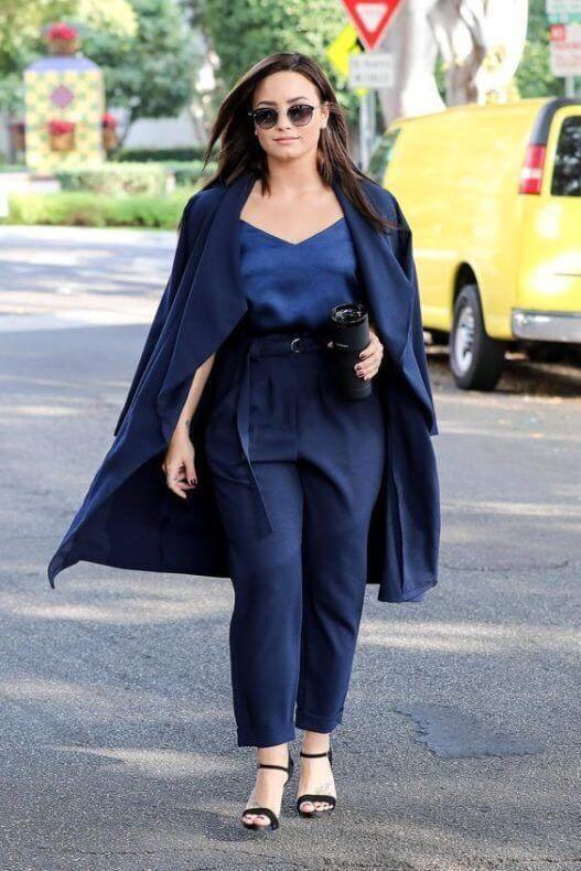 A picture of a lady in a blue monochromatic outfit.
