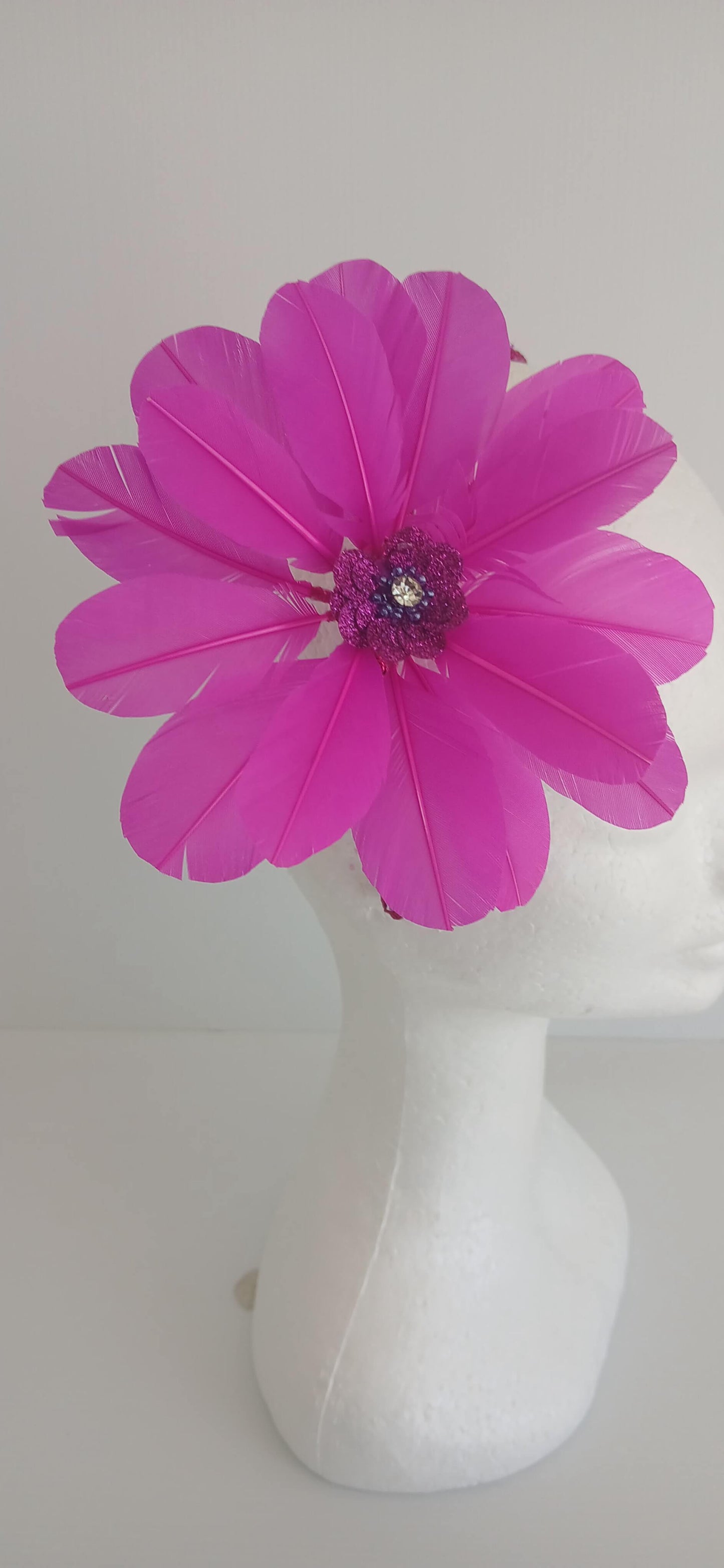 An image of the Bright Pink Feather Flower Headband by Melissa Rath Millinery