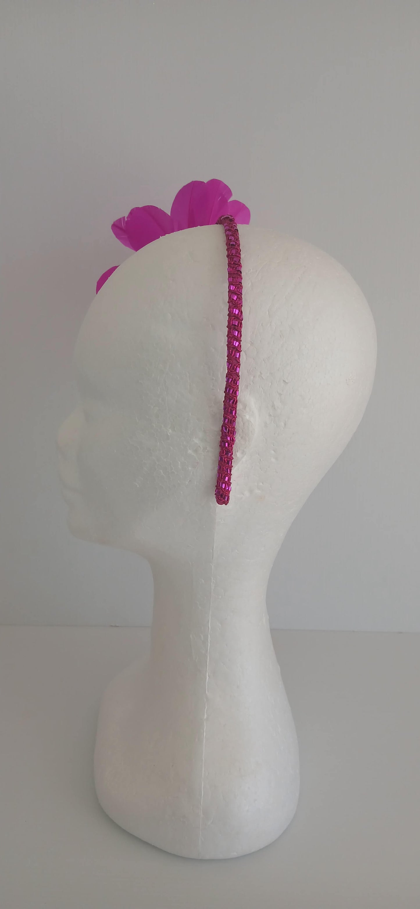 An image of the Bright Pink Feather Flower Headband by Melissa Rath Millinery