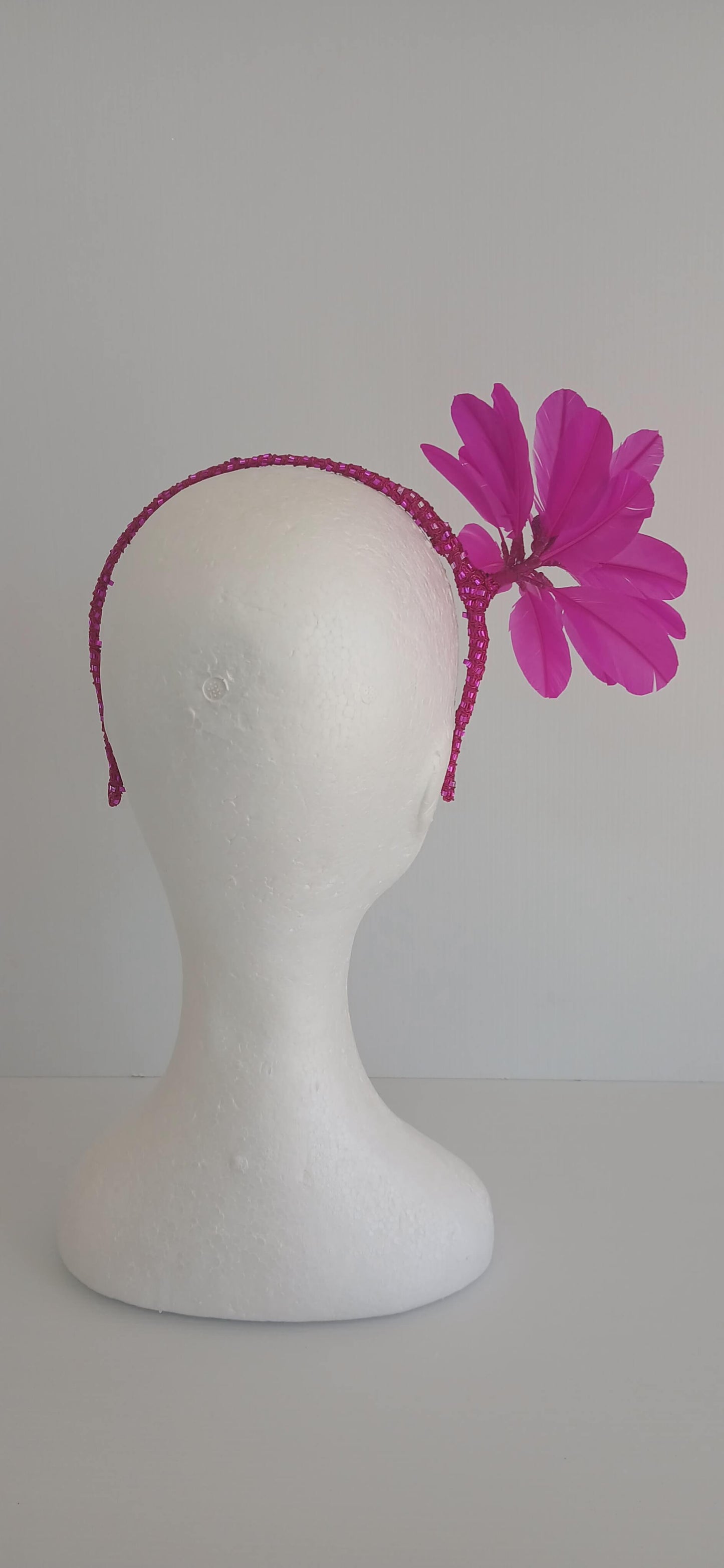 An image of the Bright Pink Feather Flower Headband by Melissa Rath Millinery