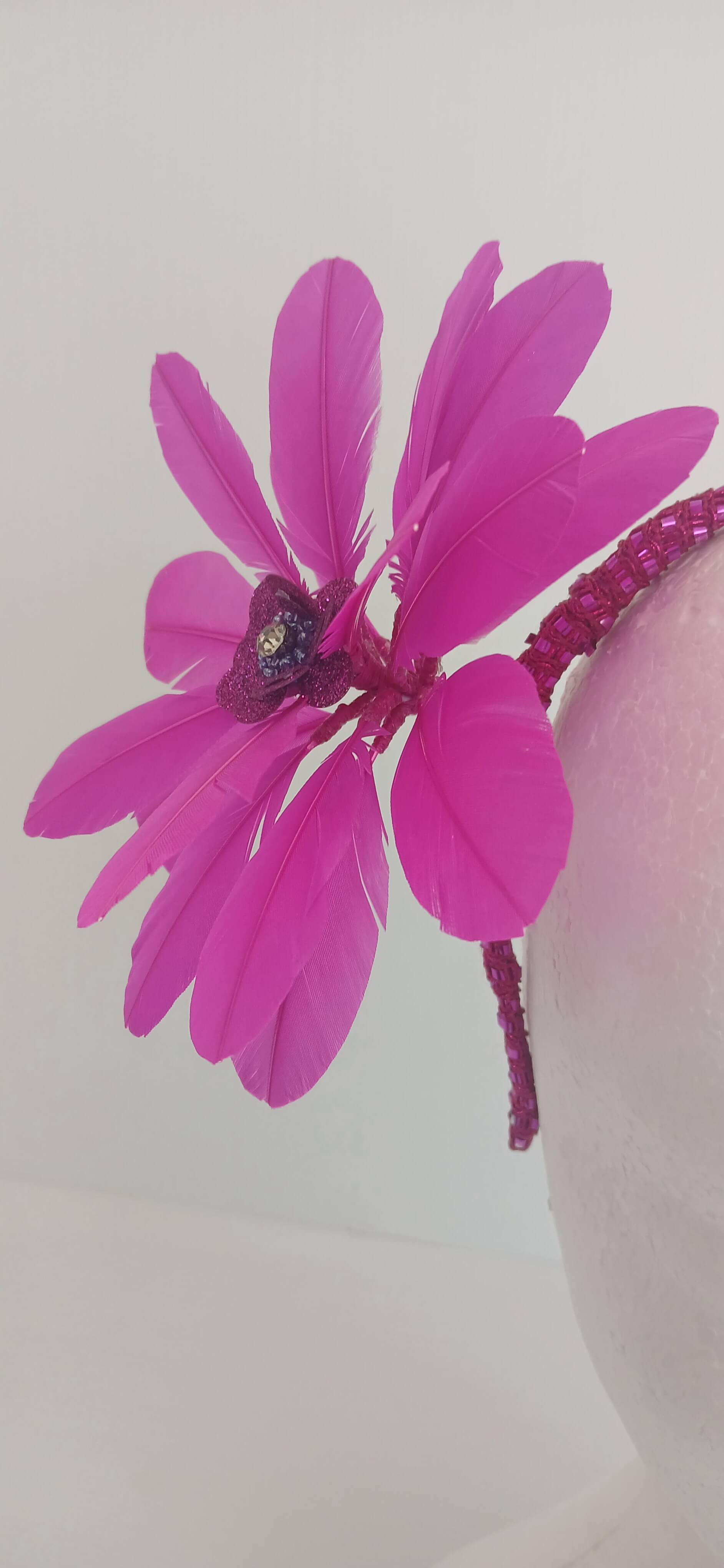 An image of the Bright Pink Feather Flower Headband by Melissa Rath Millinery