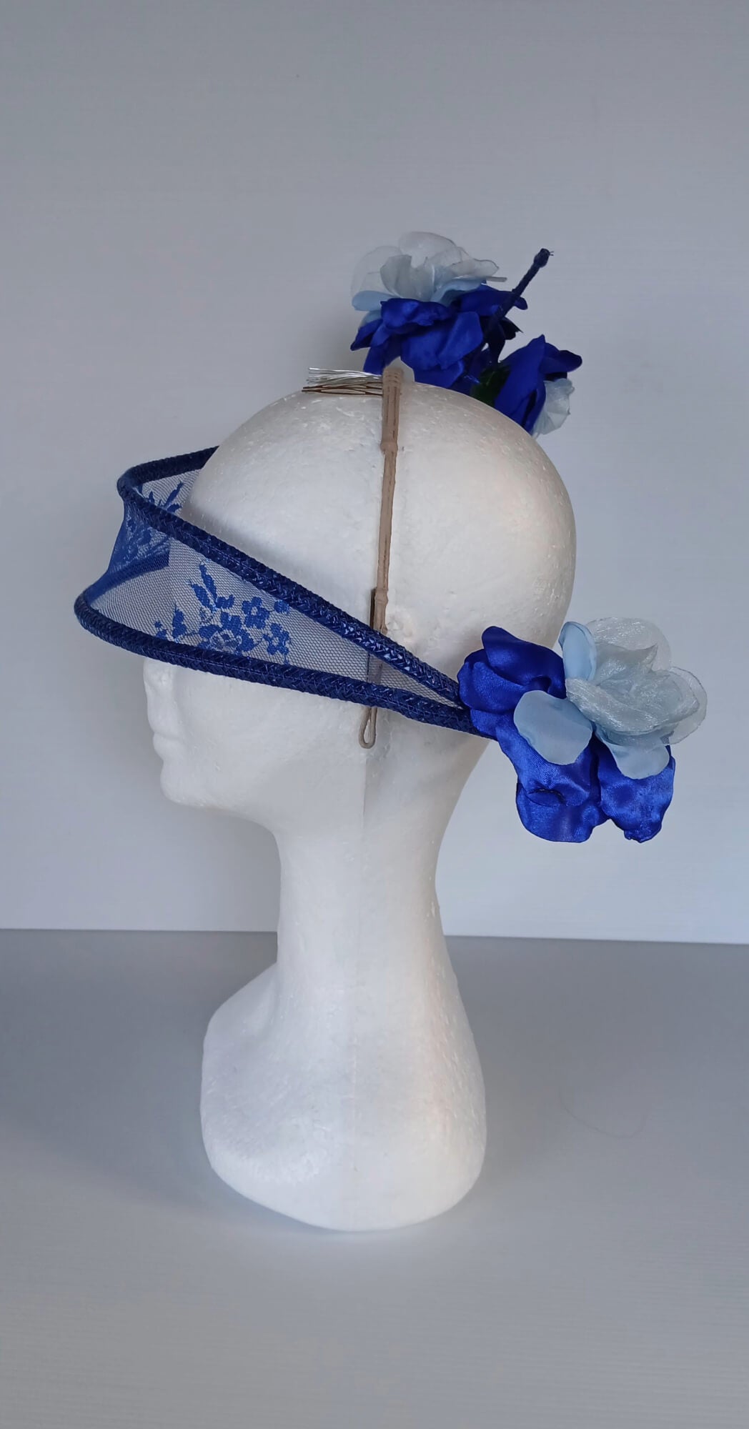 A picture of a Blue Lace Floating Millinery Headpiece by Melissa Rath Millinery.