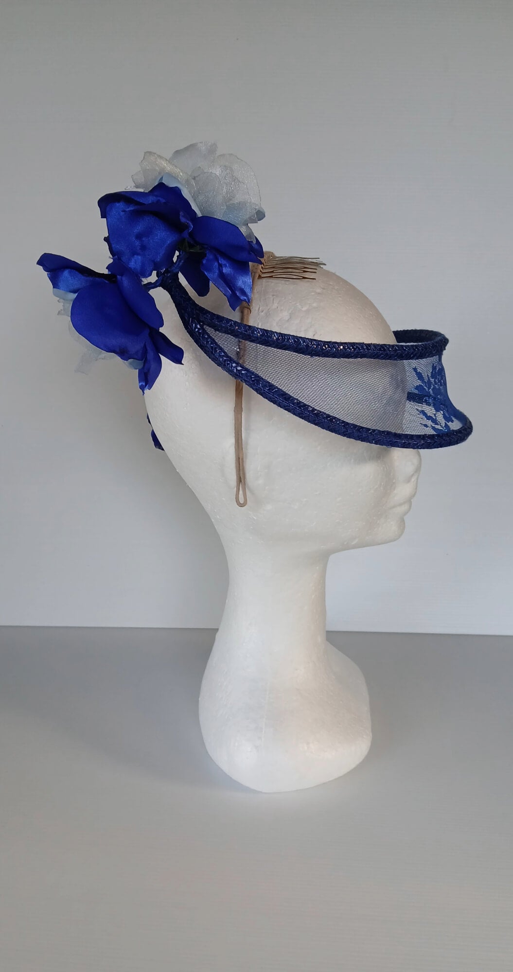 A picture of a Blue Lace Floating Millinery Headpiece by Melissa Rath Millinery.