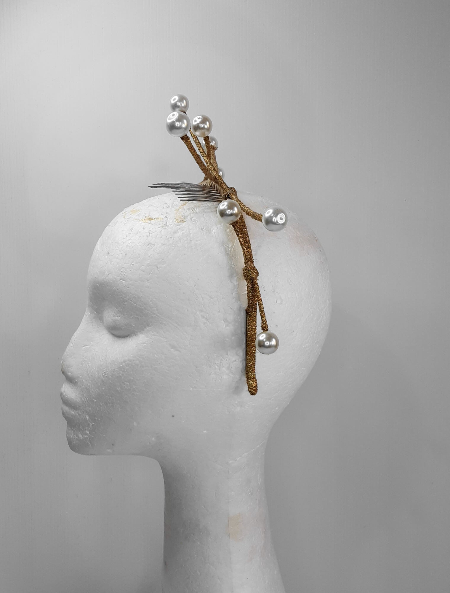 A picture of a dark gold beaded millinery headband by Melissa Rath Millinery.
