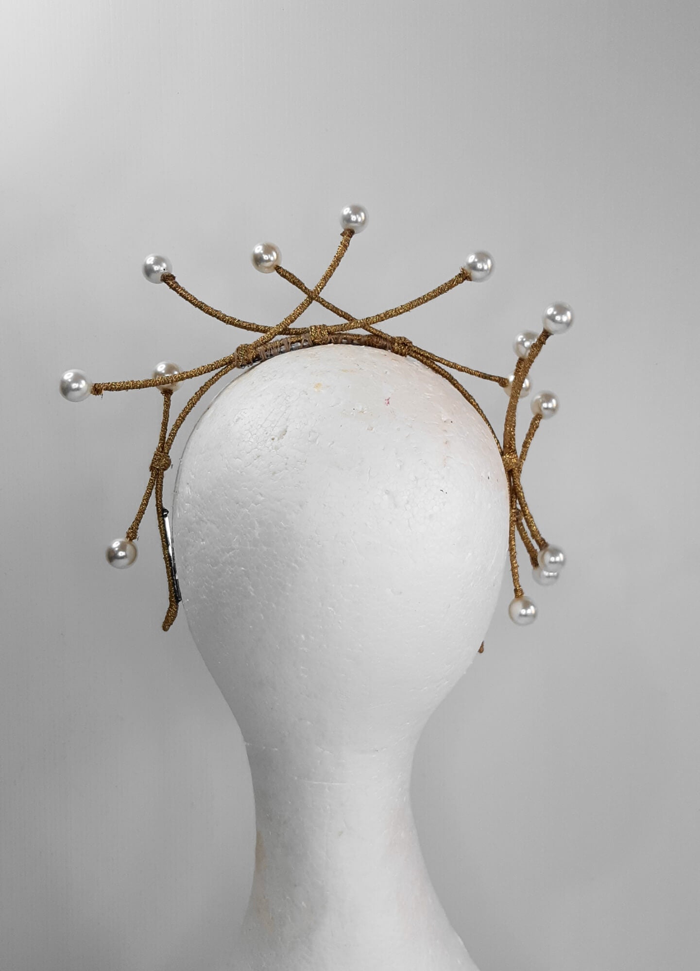 A picture of a dark gold beaded millinery headband by Melissa Rath Millinery.