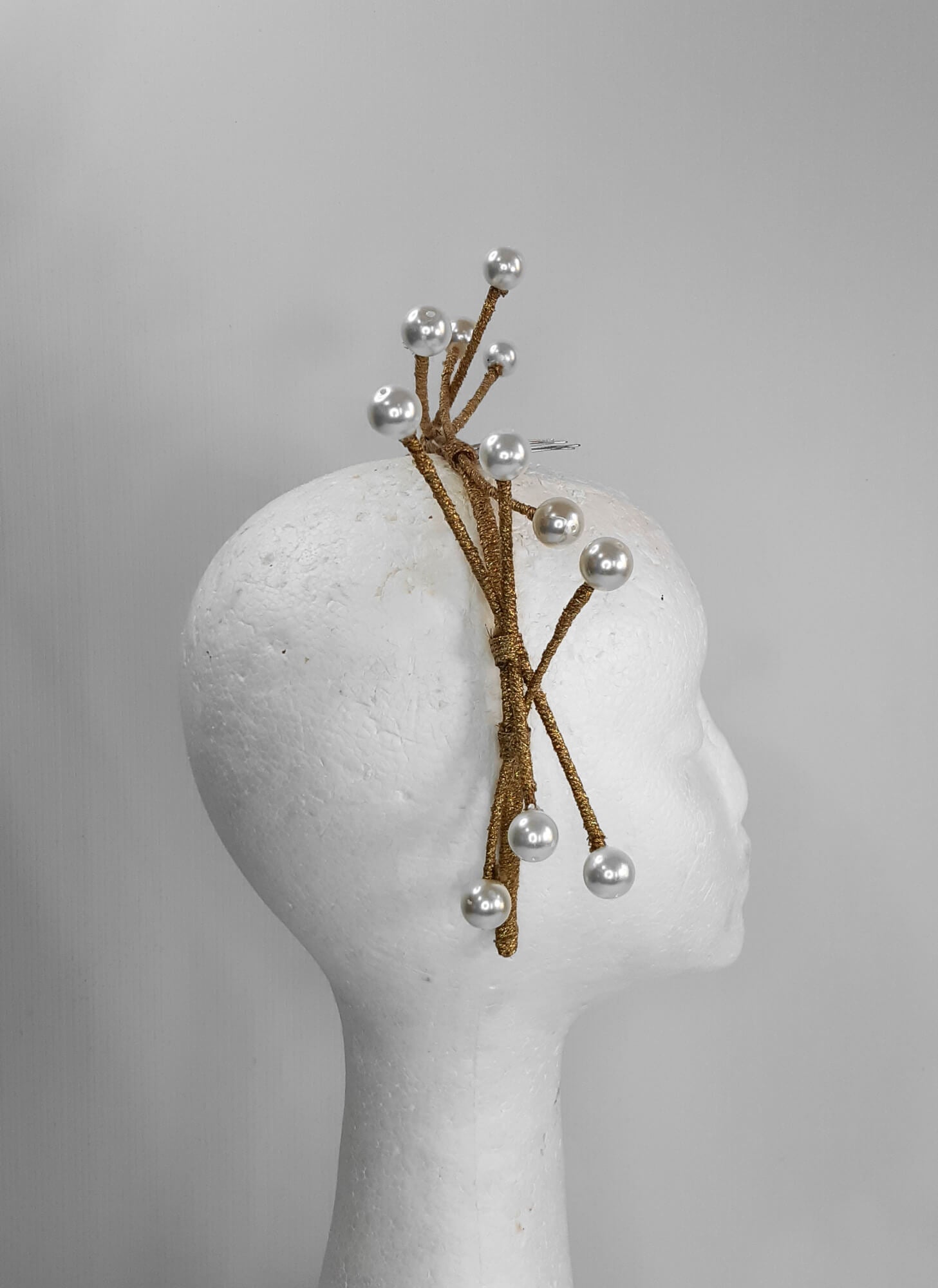 A picture of a dark gold beaded millinery headband by Melissa Rath Millinery.
