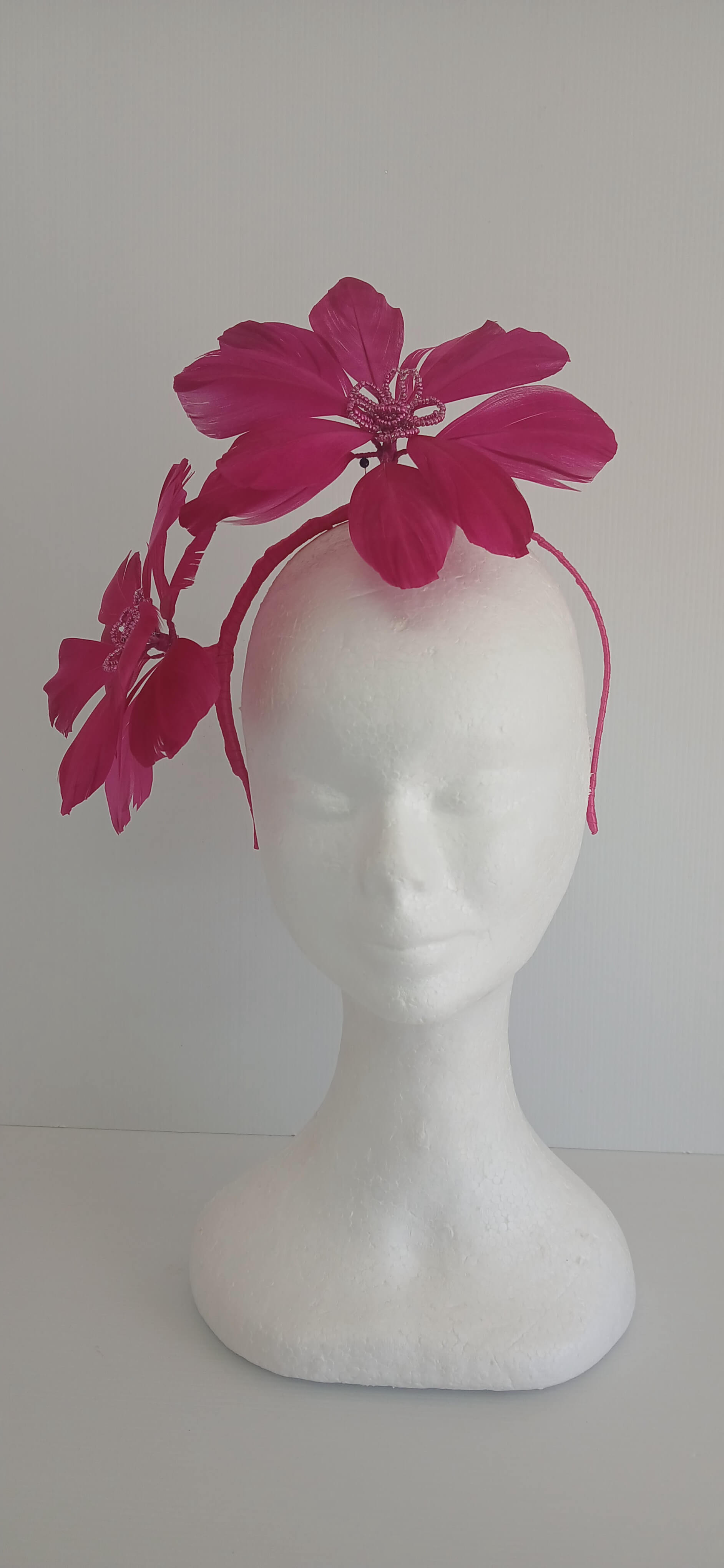 An image of the Dark Pink Feather Flower Headband by Melissa Rath Millinery