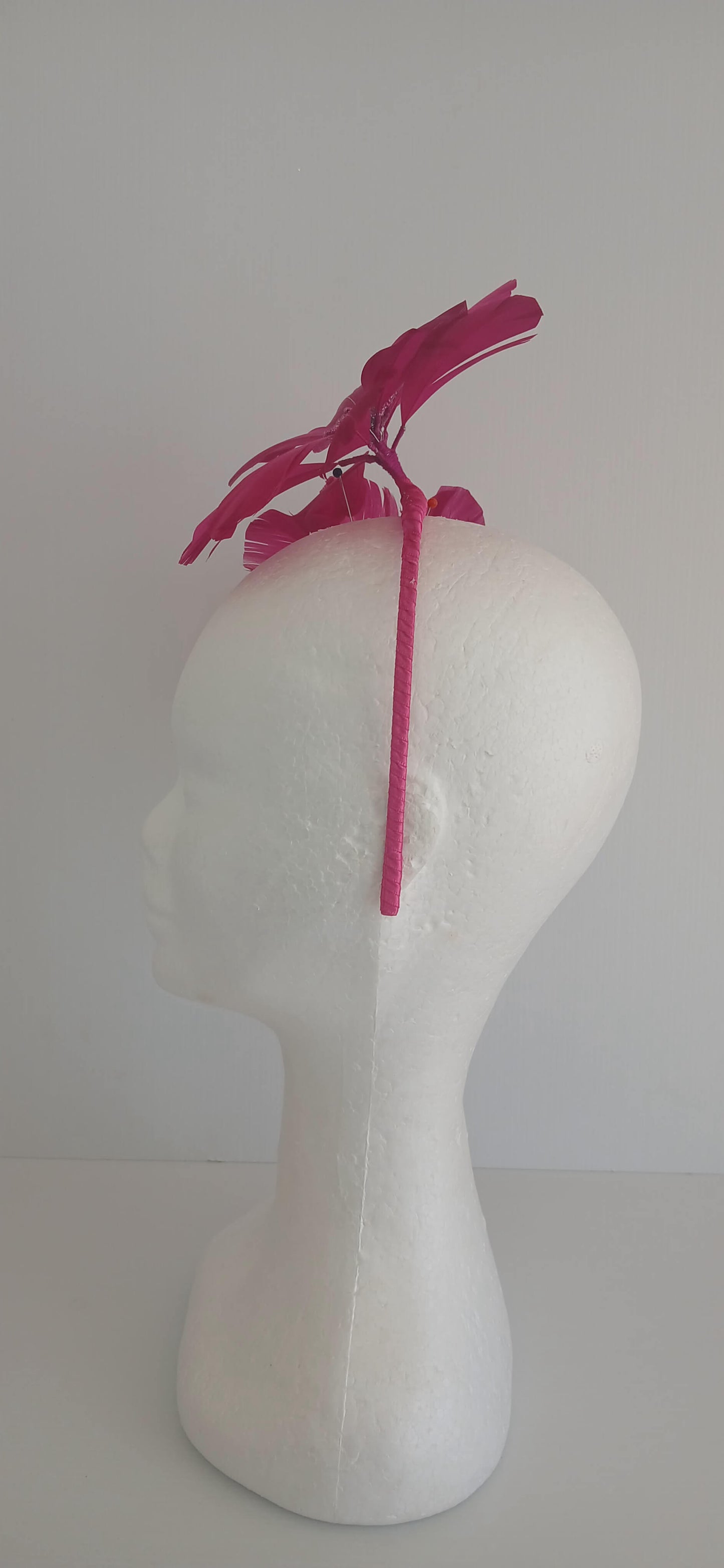 An image of the Dark Pink Feather Flower Headband by Melissa Rath Millinery