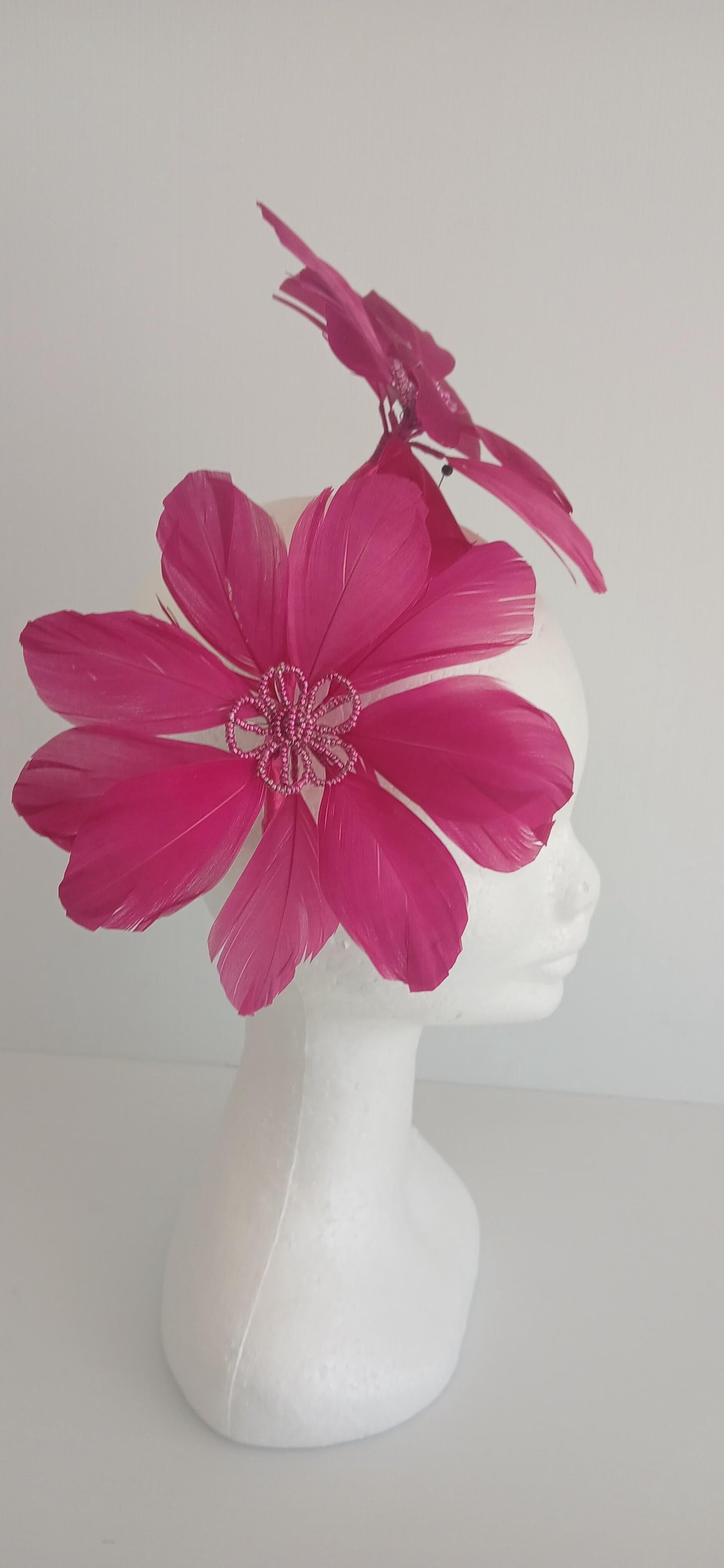 An image of the Dark Pink Feather Flower Headband by Melissa Rath Millinery