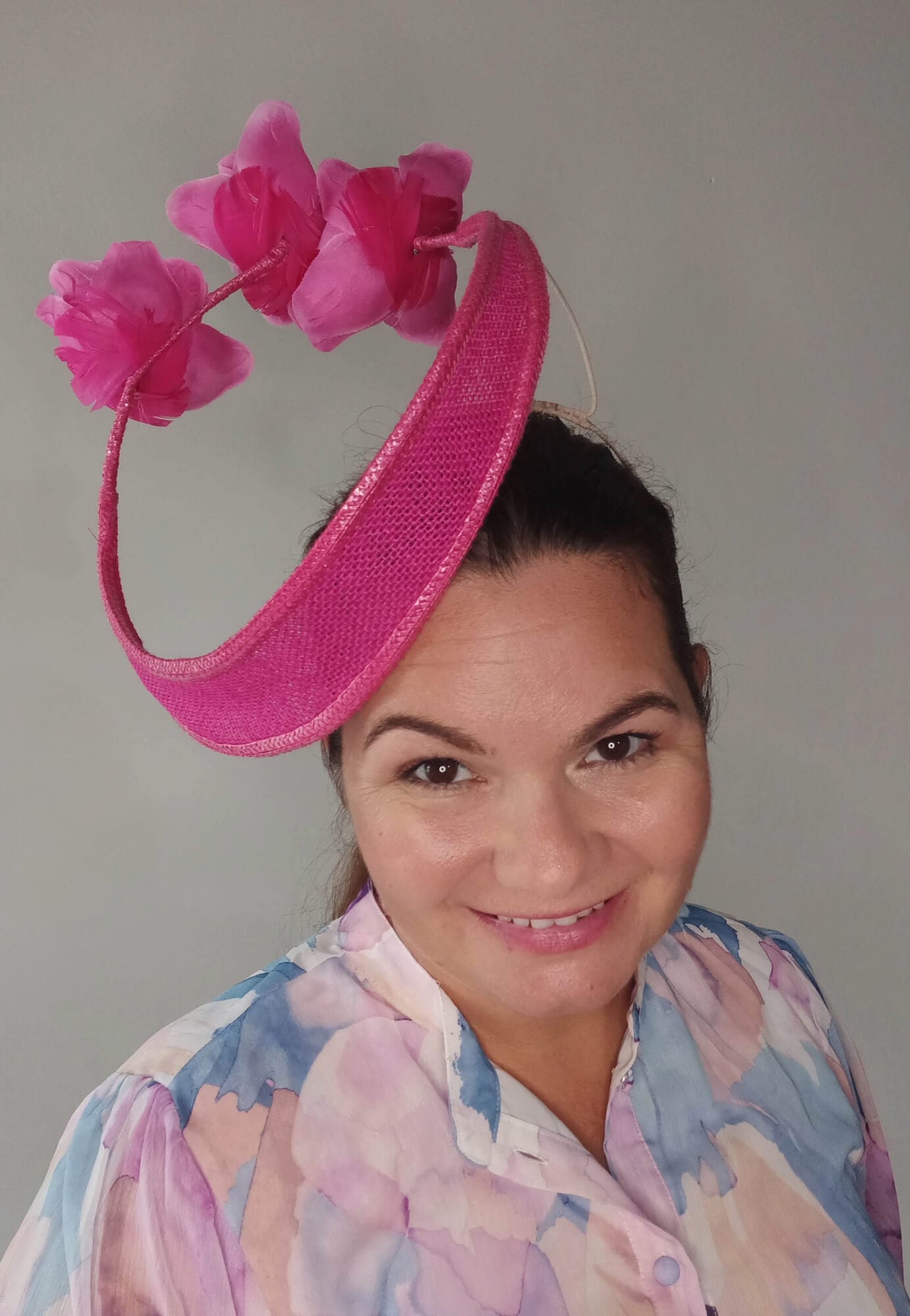 A picture of a Pink Floating Millinery Headpiece by Melissa Rath Millinery.