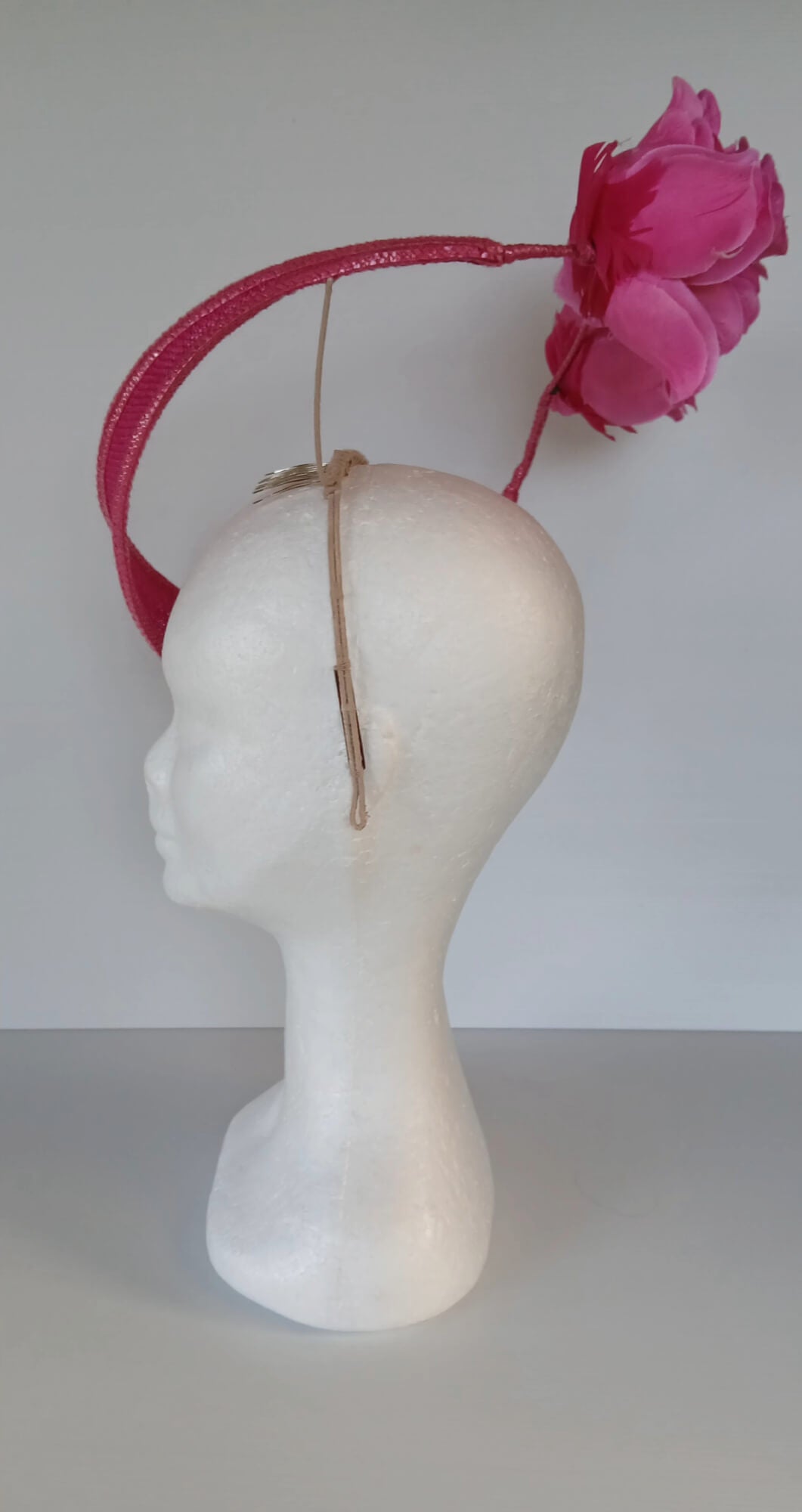 A picture of a Pink Floating Millinery Headpiece by Melissa Rath Millinery.