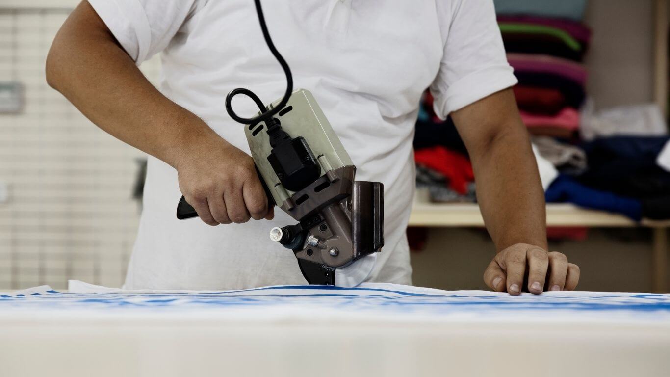 An image of someone cutting fabric.