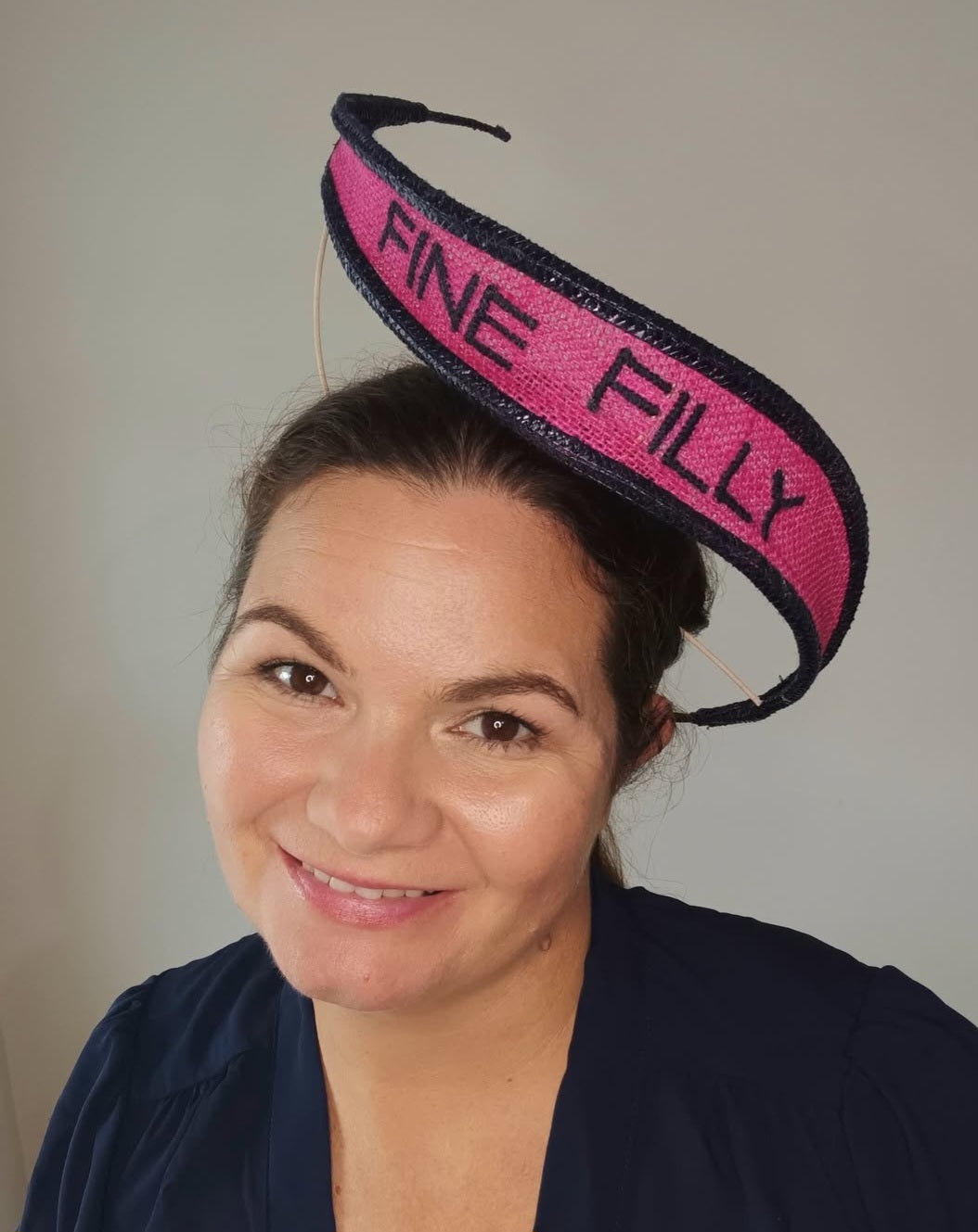 A picture of a Pink and Navy Floating Headpiece by Melissa Rath Millinery.