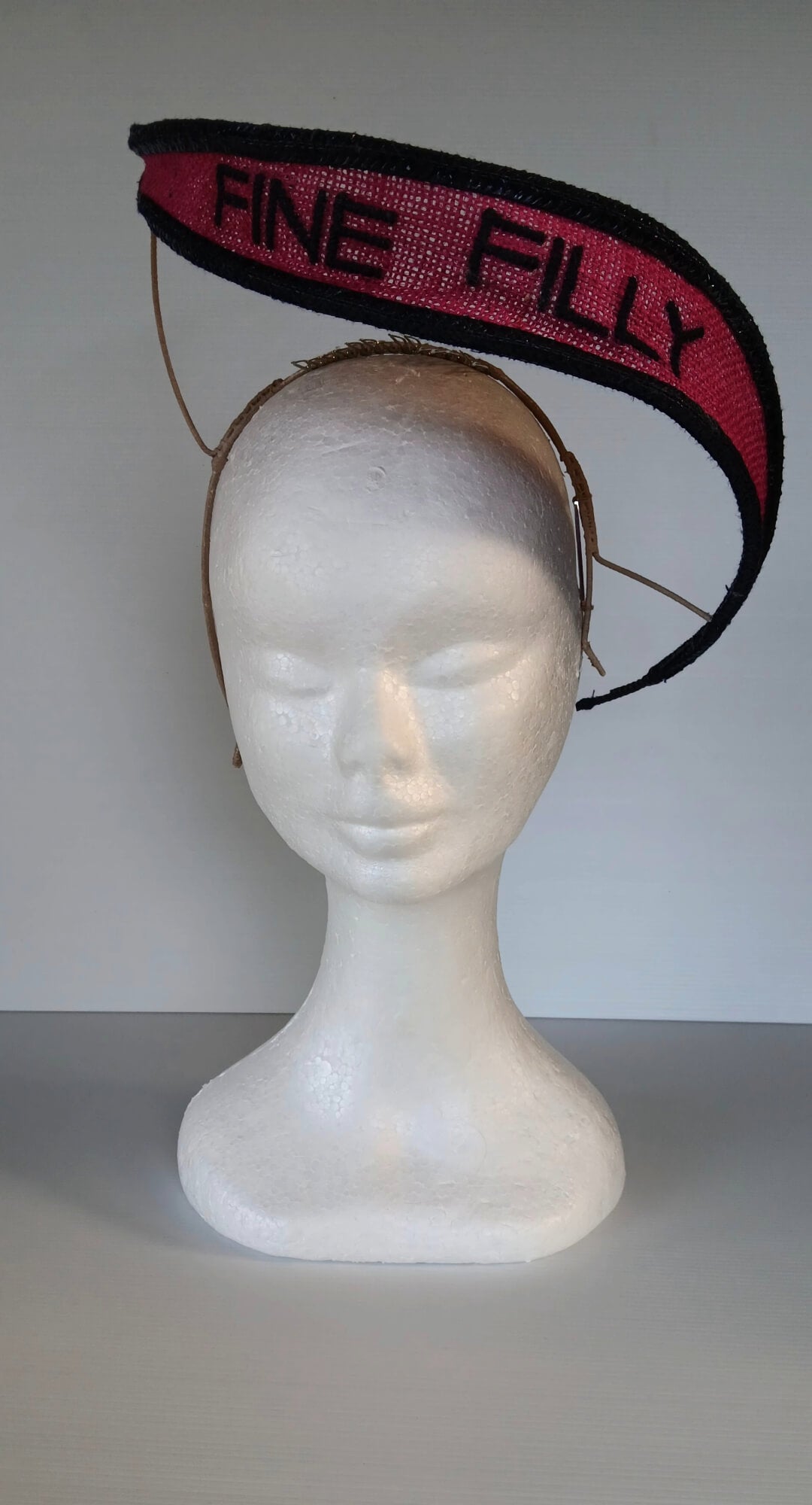 A picture of a Pink and Navy Floating Headpiece by Melissa Rath Millinery.