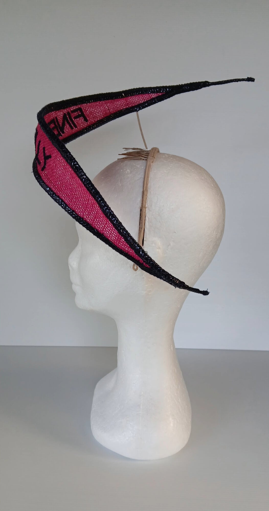 A picture of a Pink and Navy Floating Headpiece by Melissa Rath Millinery.