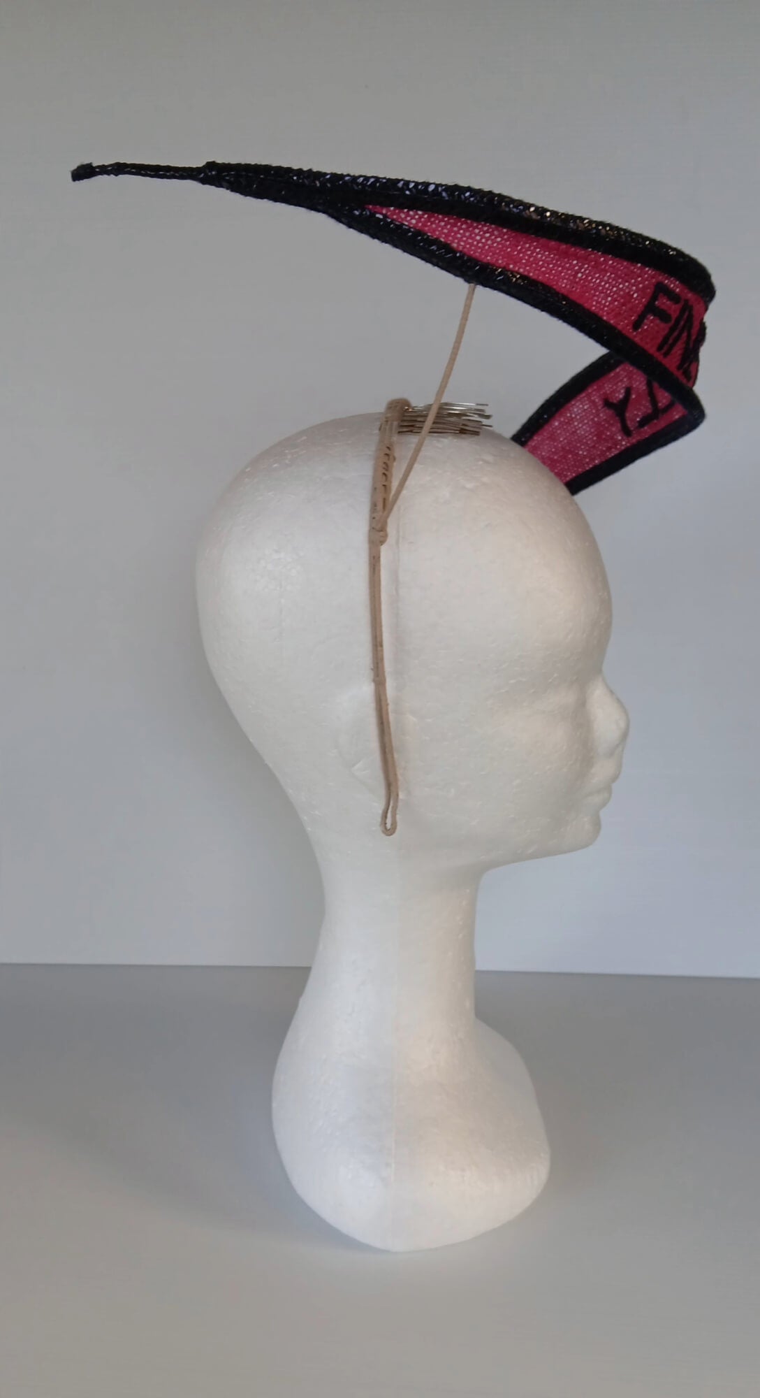 A picture of a Pink and Navy Floating Headpiece by Melissa Rath Millinery.