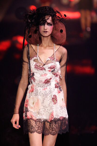 A picture of a model on the catwalk for Galliano SS 2010.
