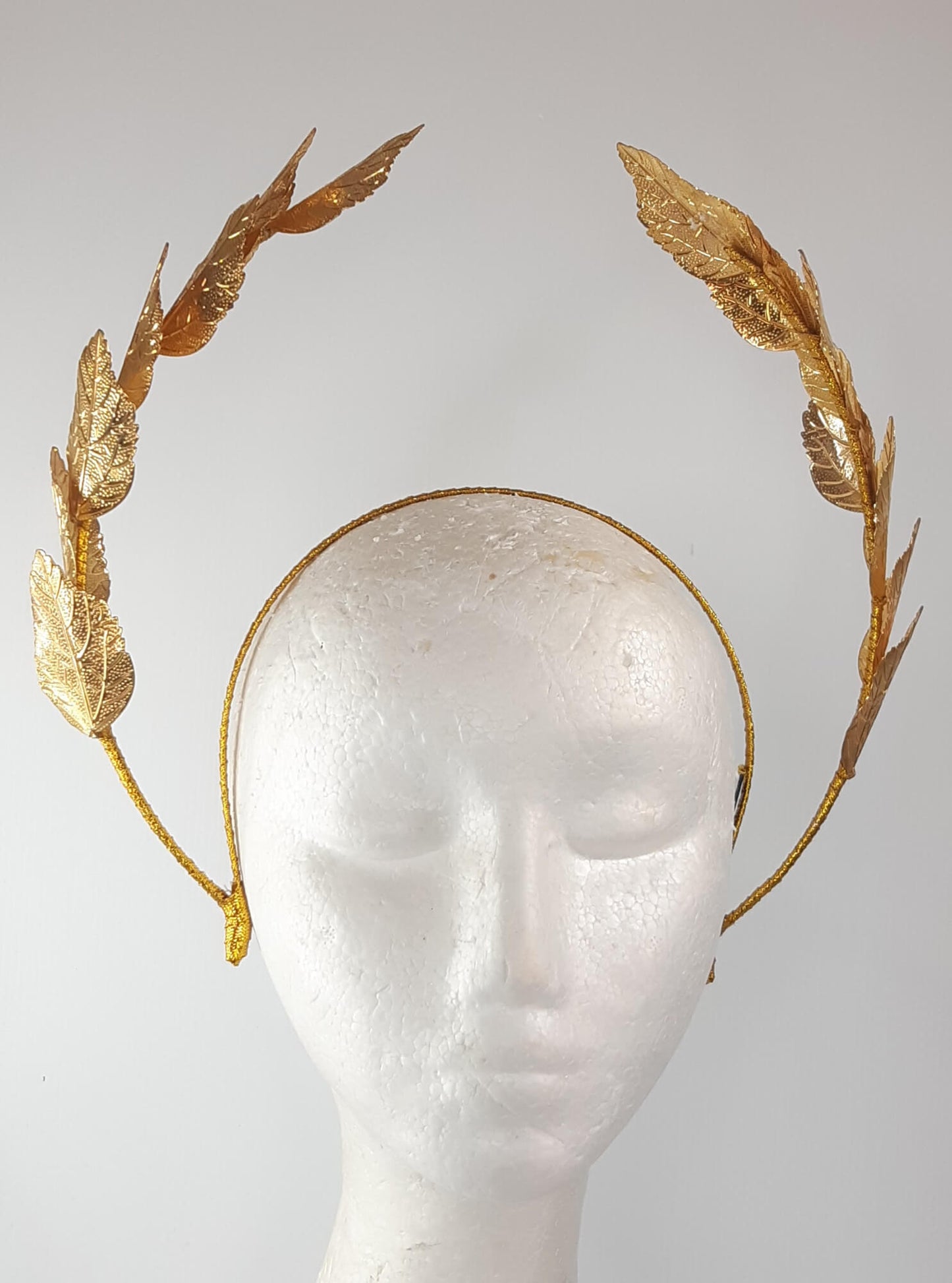 A picture of a Gold Leaf Millinery Headband by Melissa Rath Millinery