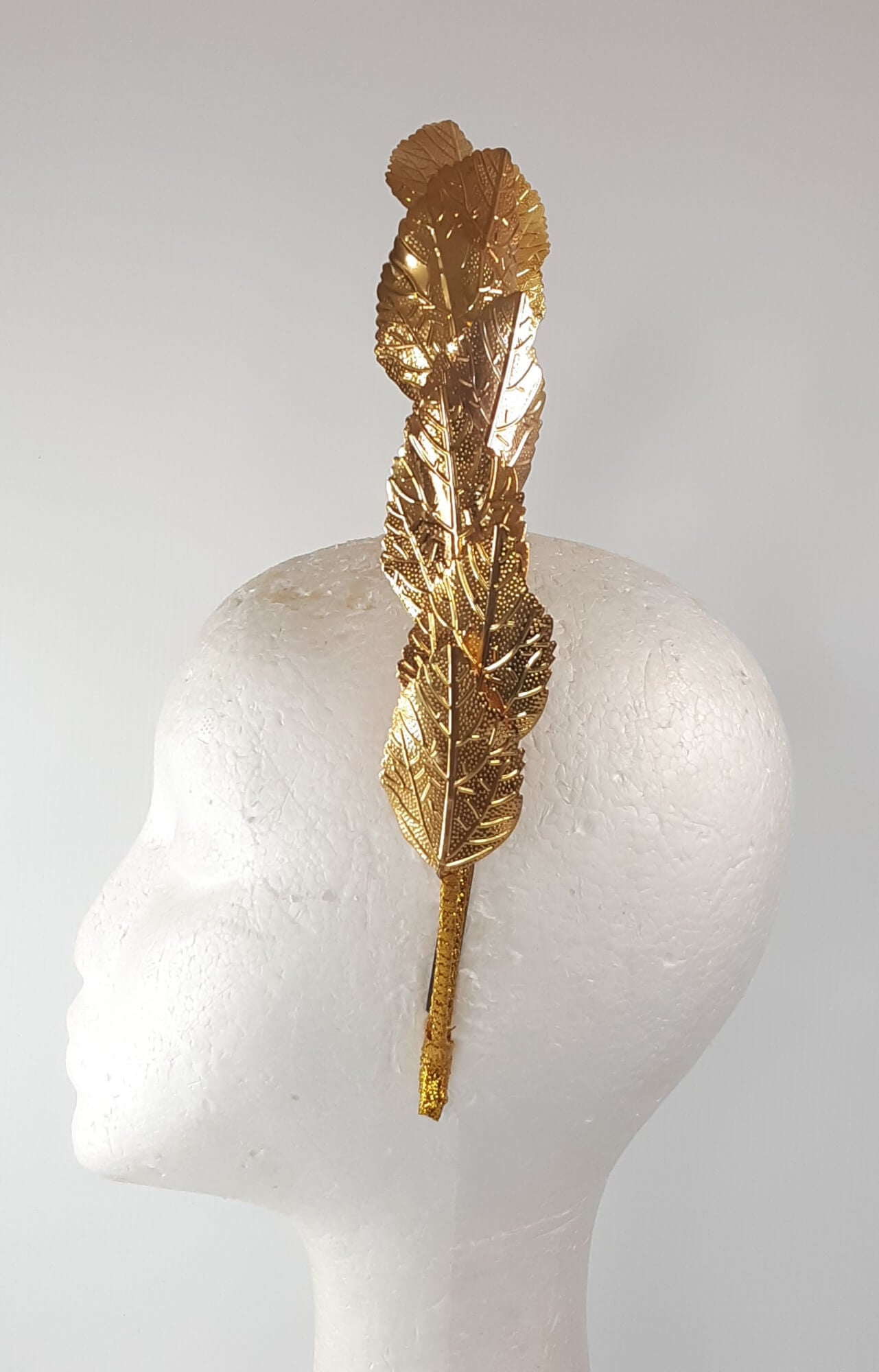 A picture of a Gold Leaf Millinery Headband by Melissa Rath Millinery