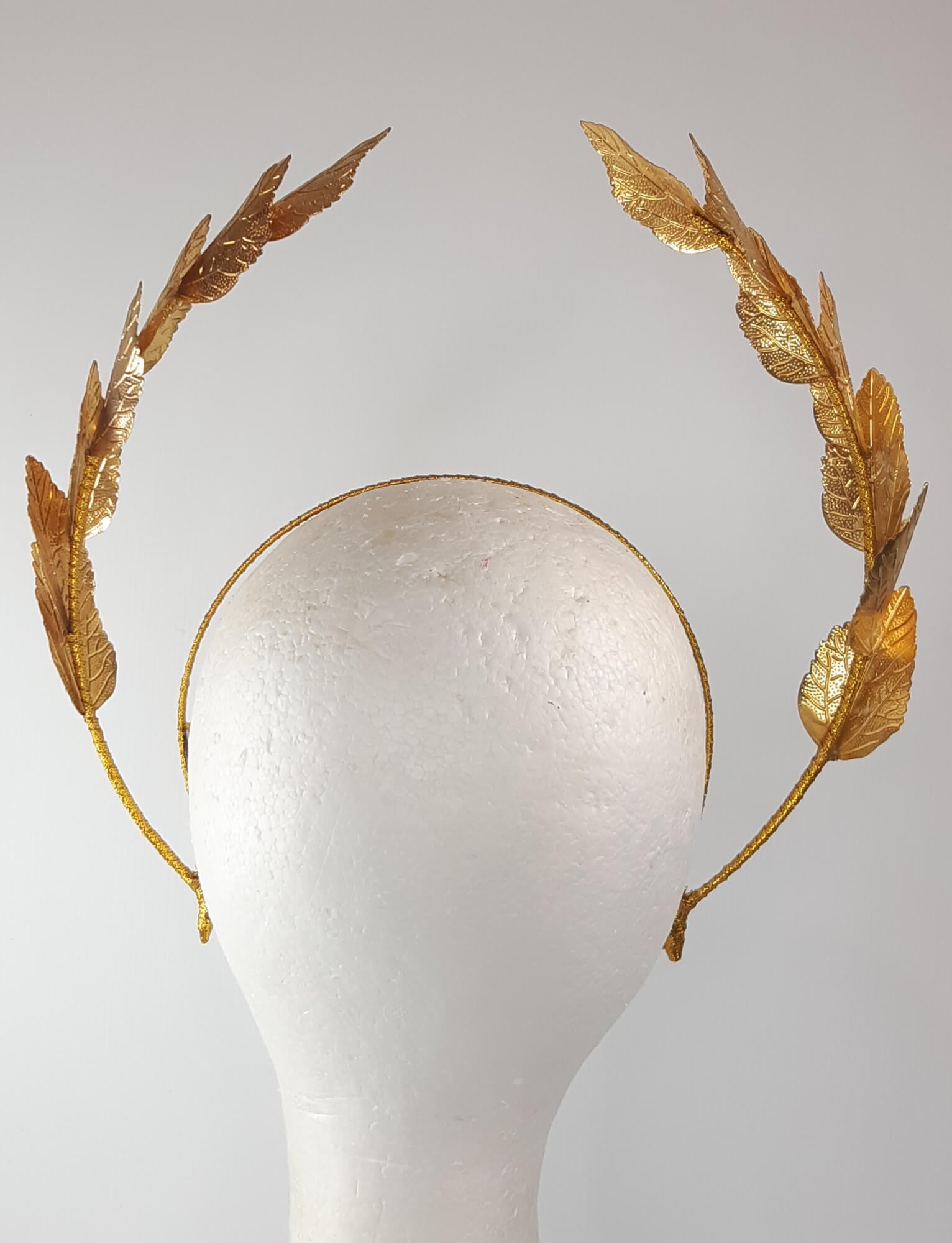 A picture of a Gold Leaf Millinery Headband by Melissa Rath Millinery