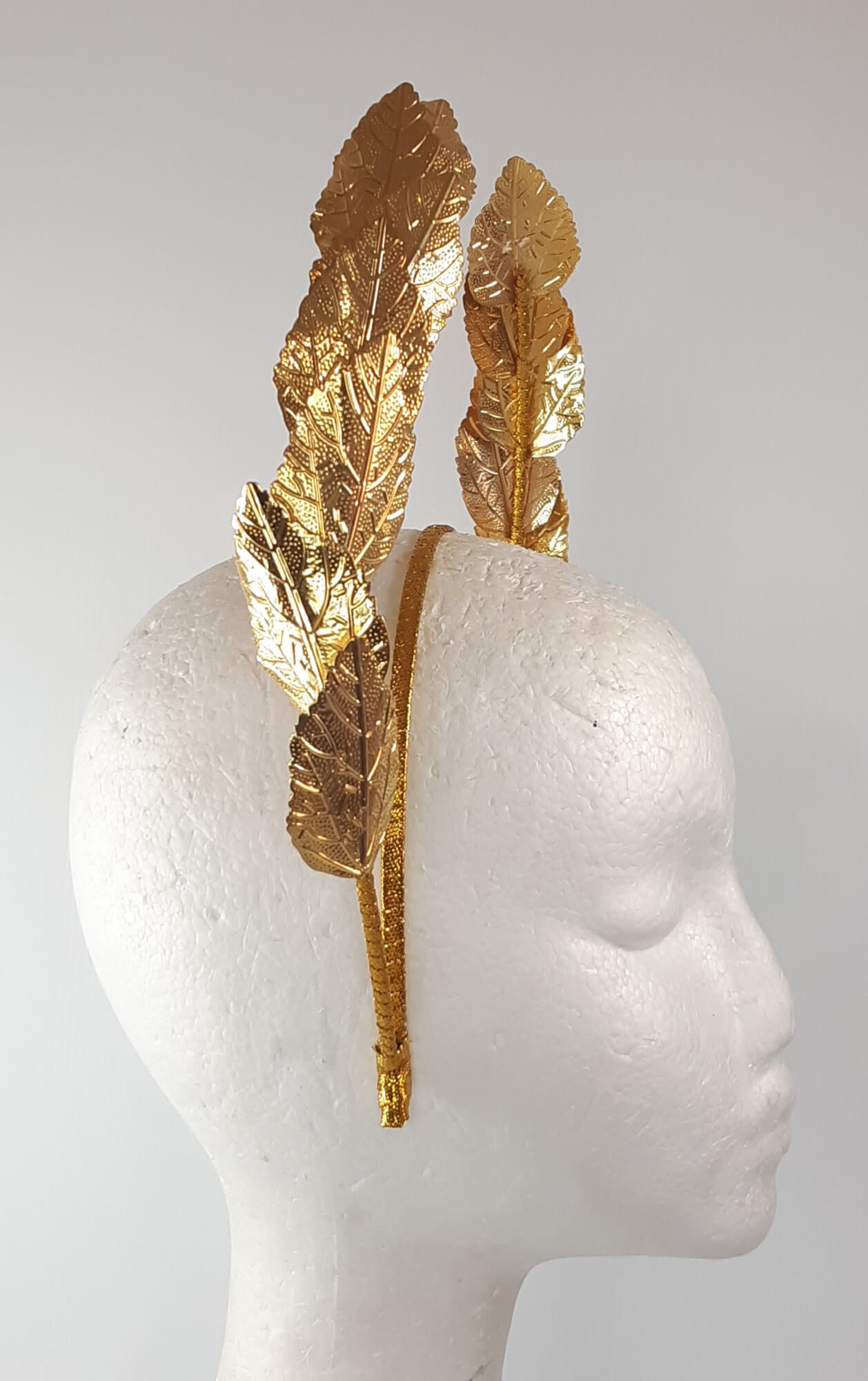 A picture of a Gold Leaf Millinery Headband by Melissa Rath Millinery