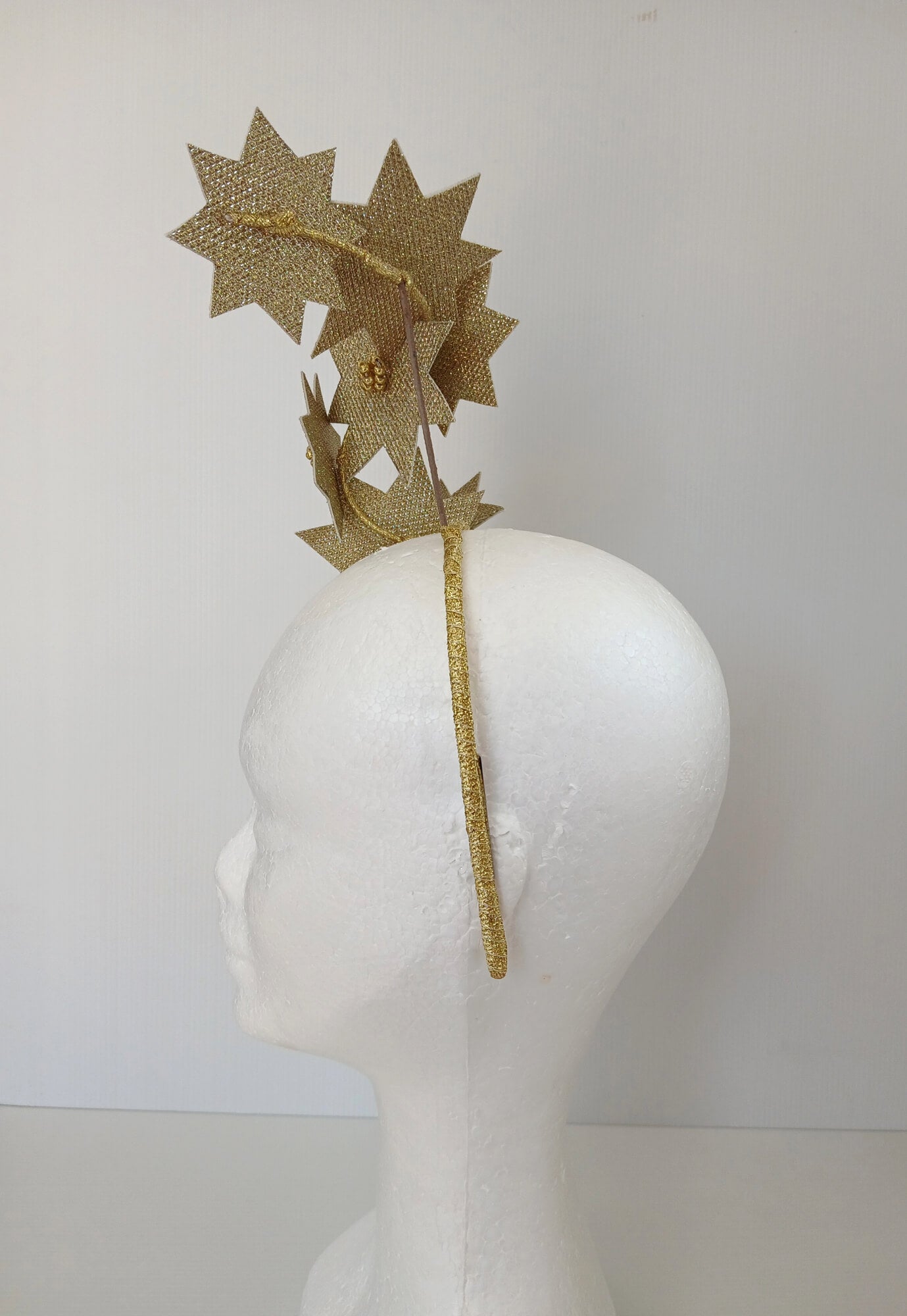 A picture of a Gold Pleather Millinery Fascinator by Melissa Rath Millinery