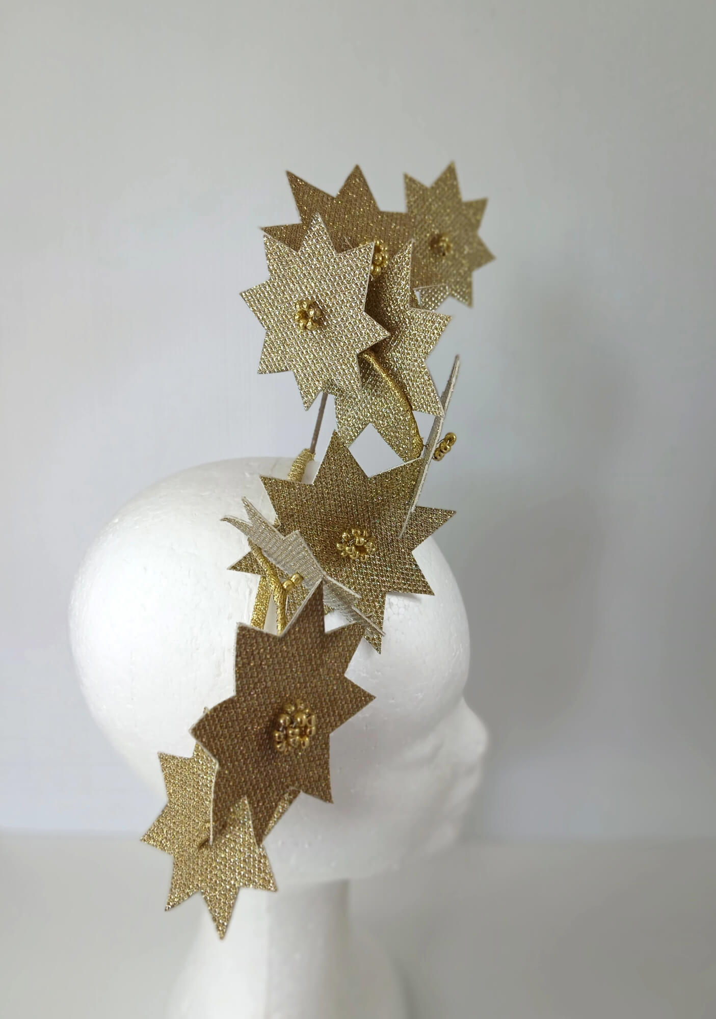 A picture of a Gold Pleather Millinery Fascinator by Melissa Rath Millinery