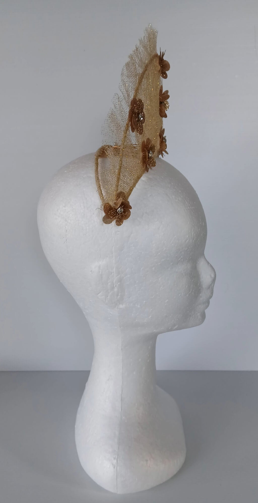 A picture of a Gold Tulle Crown by Melissa Rath Millinery